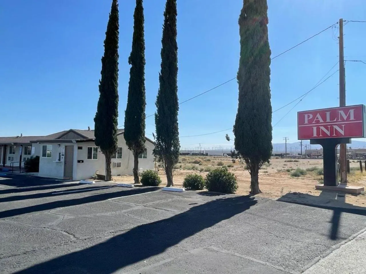 Property logo or sign in Palm Inn
