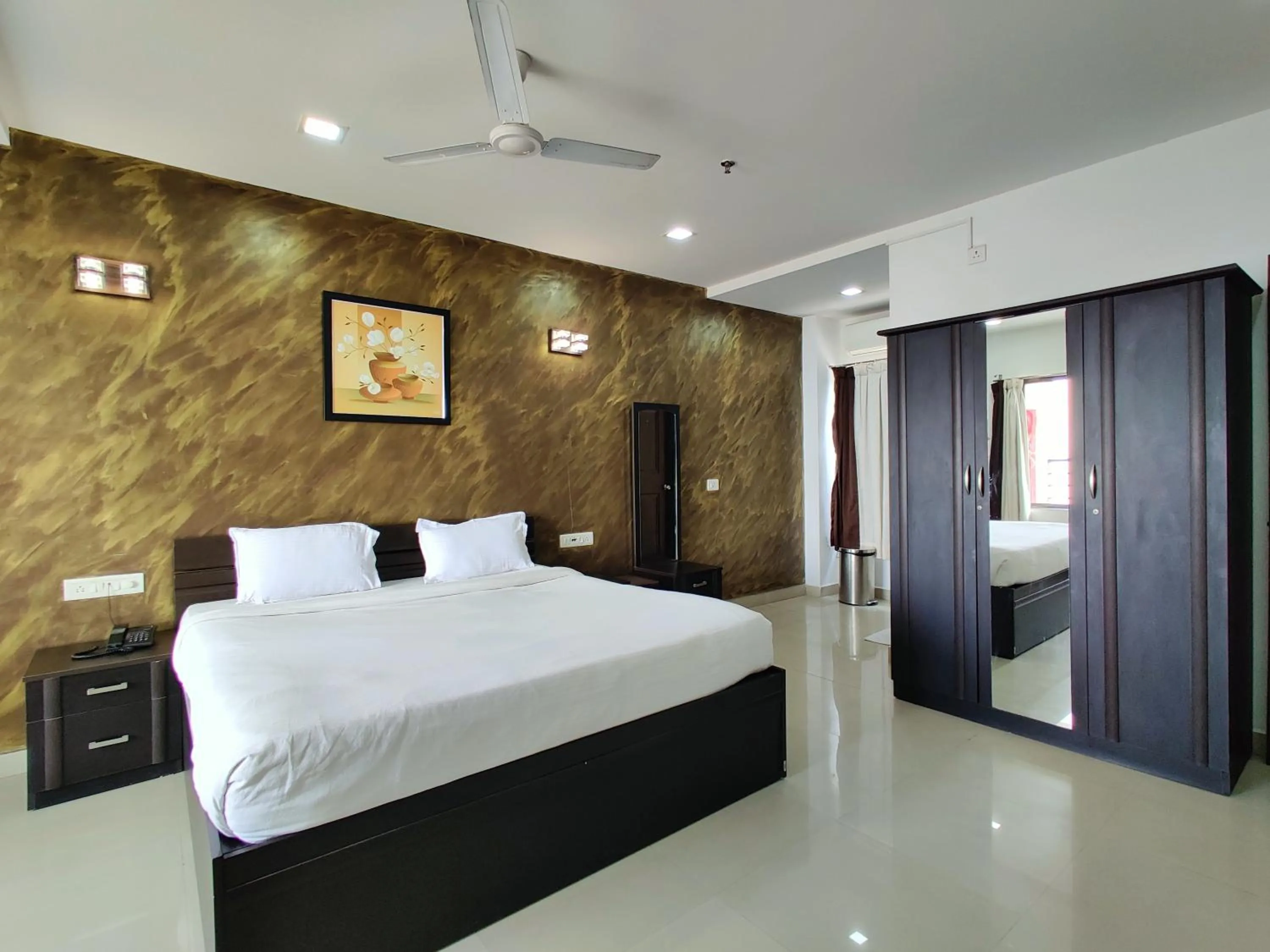 Bed in Golden Chariot Hotel Daman