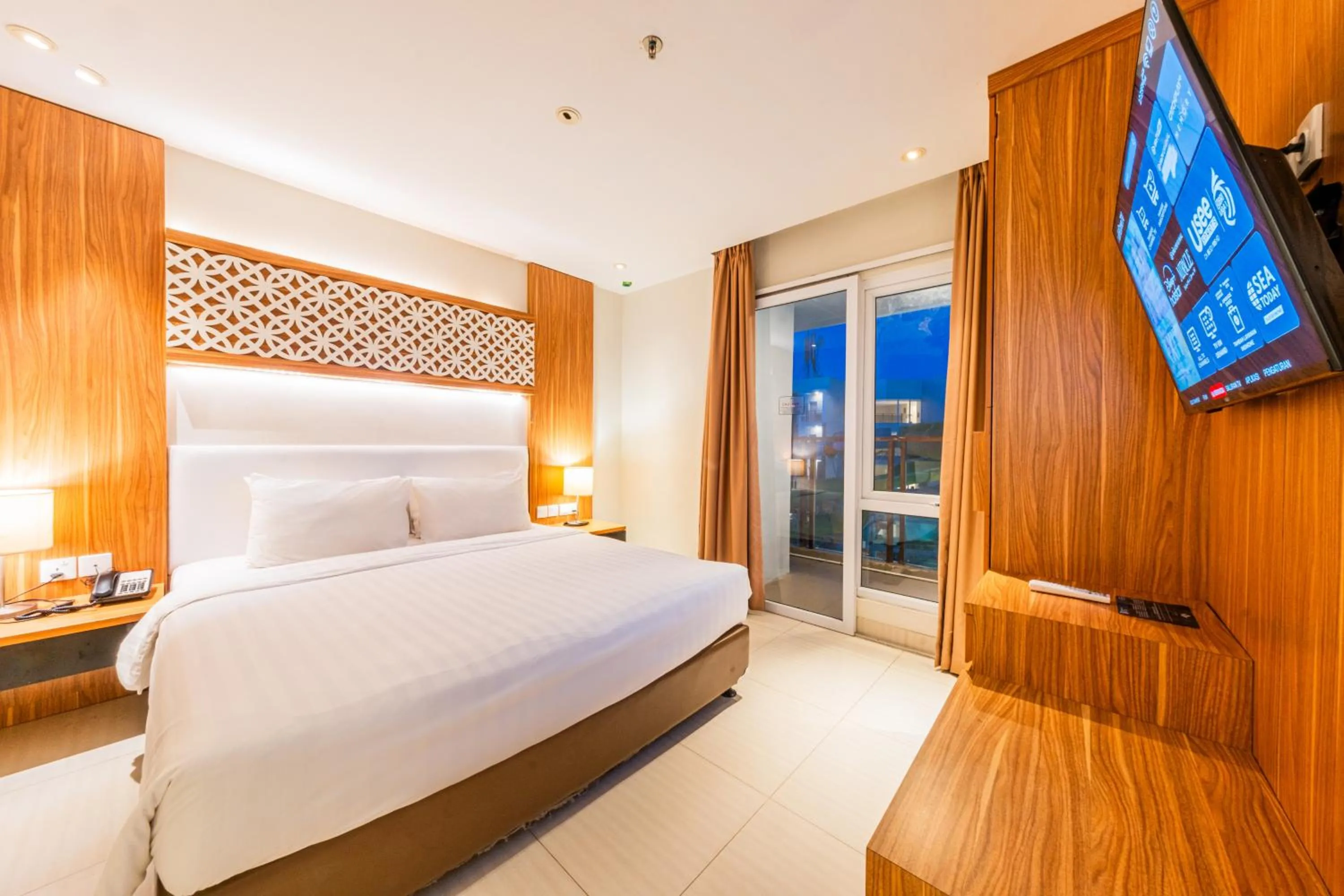 Communal lounge/ TV room, Bed in Astara Hotel Balikpapan