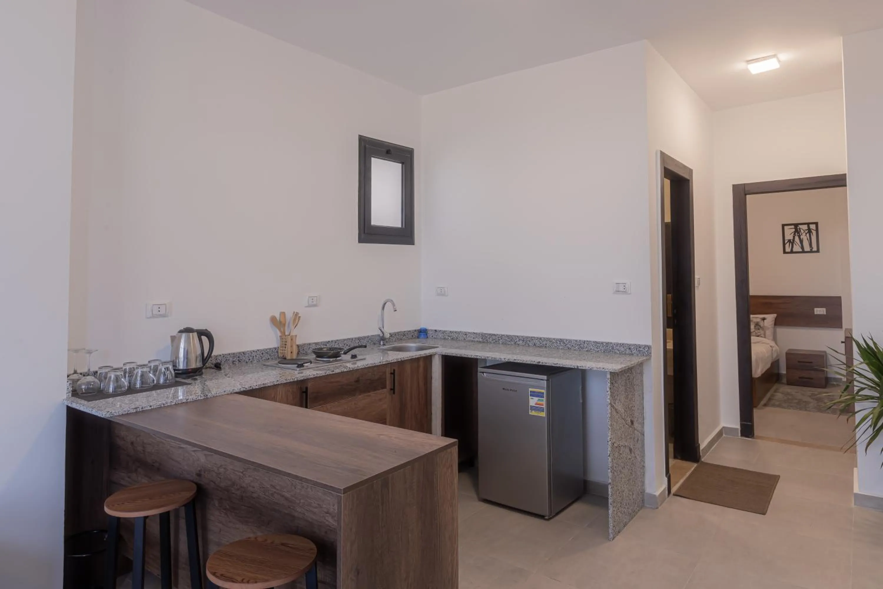 Kitchen or kitchenette, Bed in SOLA INN Hotel Hurghada