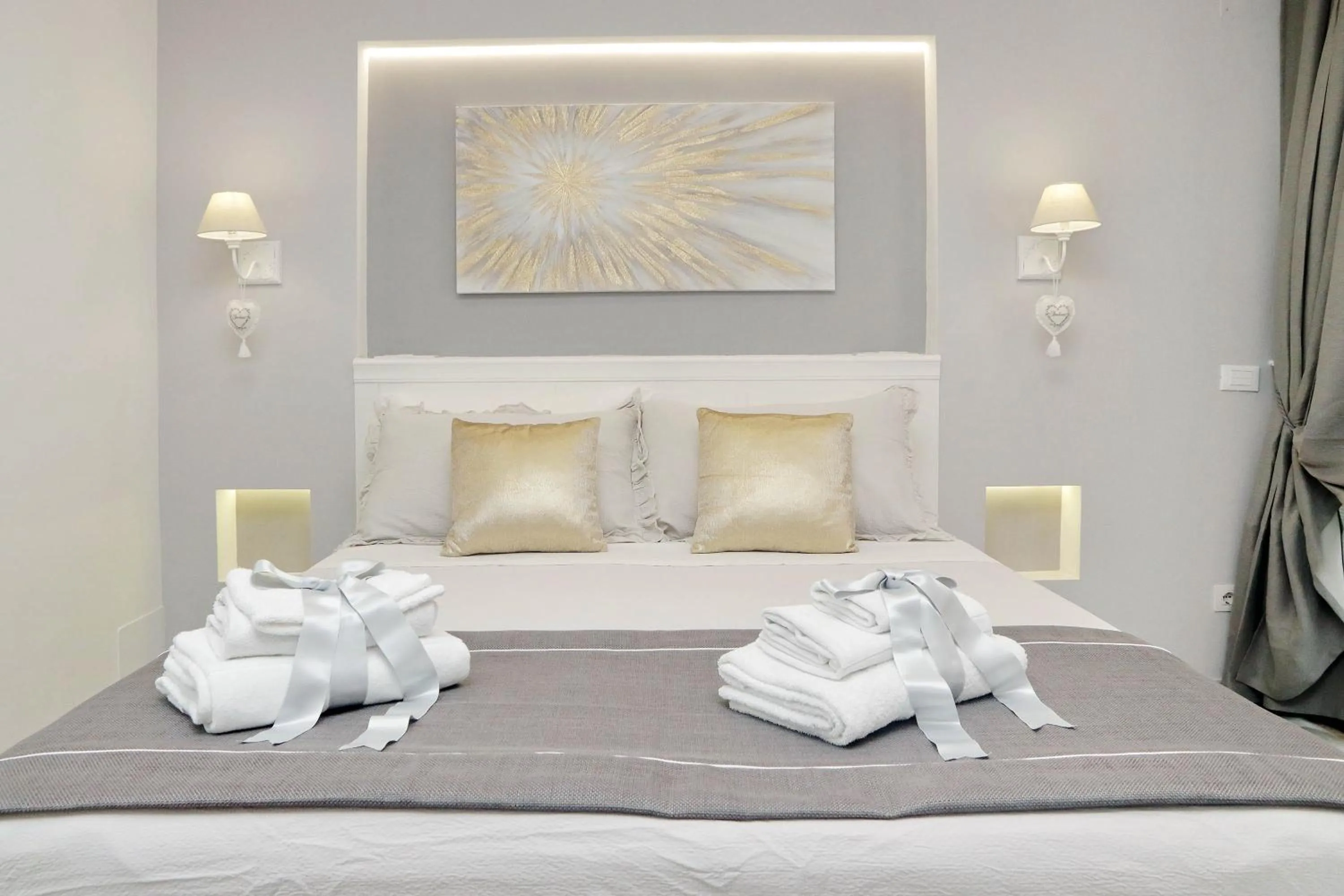Bed in Roman Holiday Suites