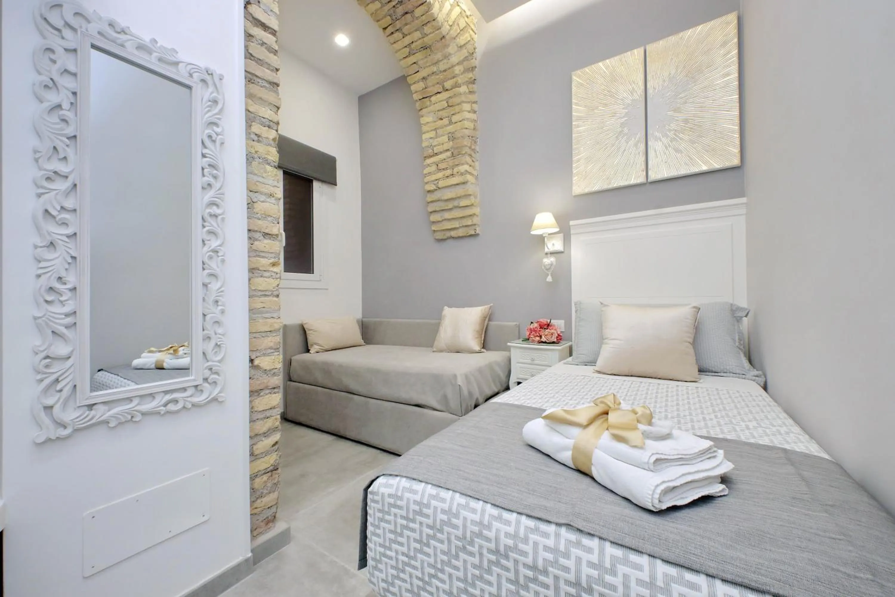 Bed in Roman Holiday Suites