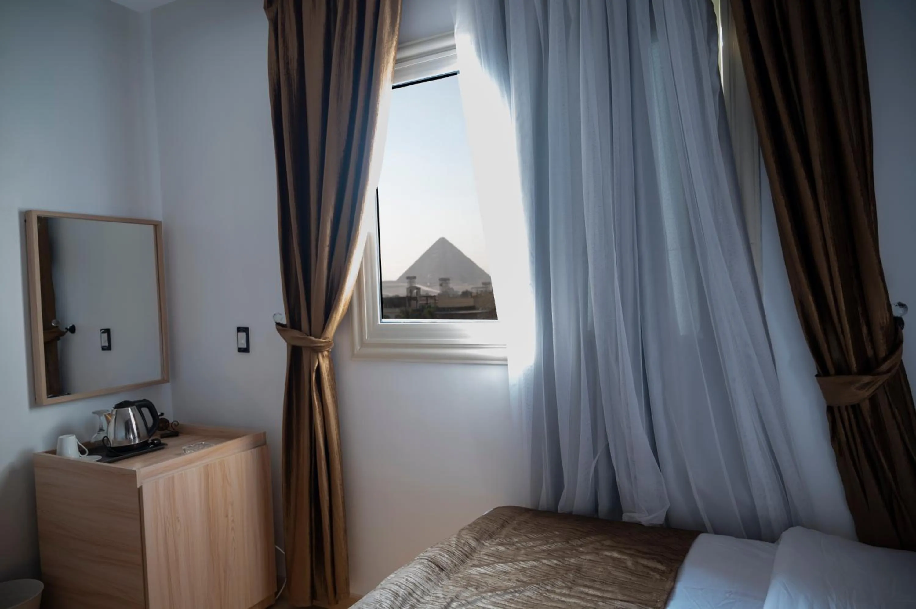 Bed in Palm Pyramids View INN
