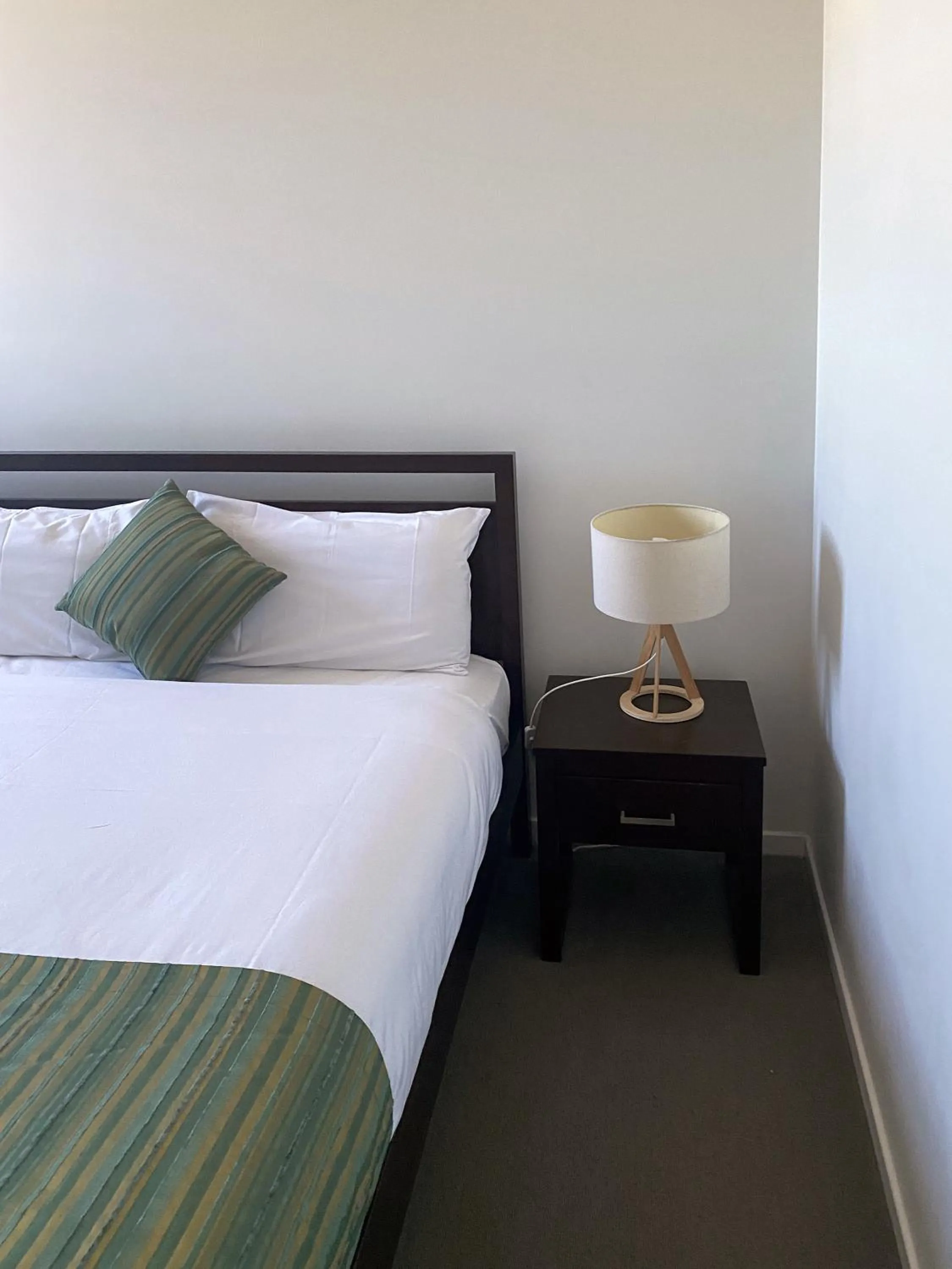 Bed in Curtis Central Apartments Official