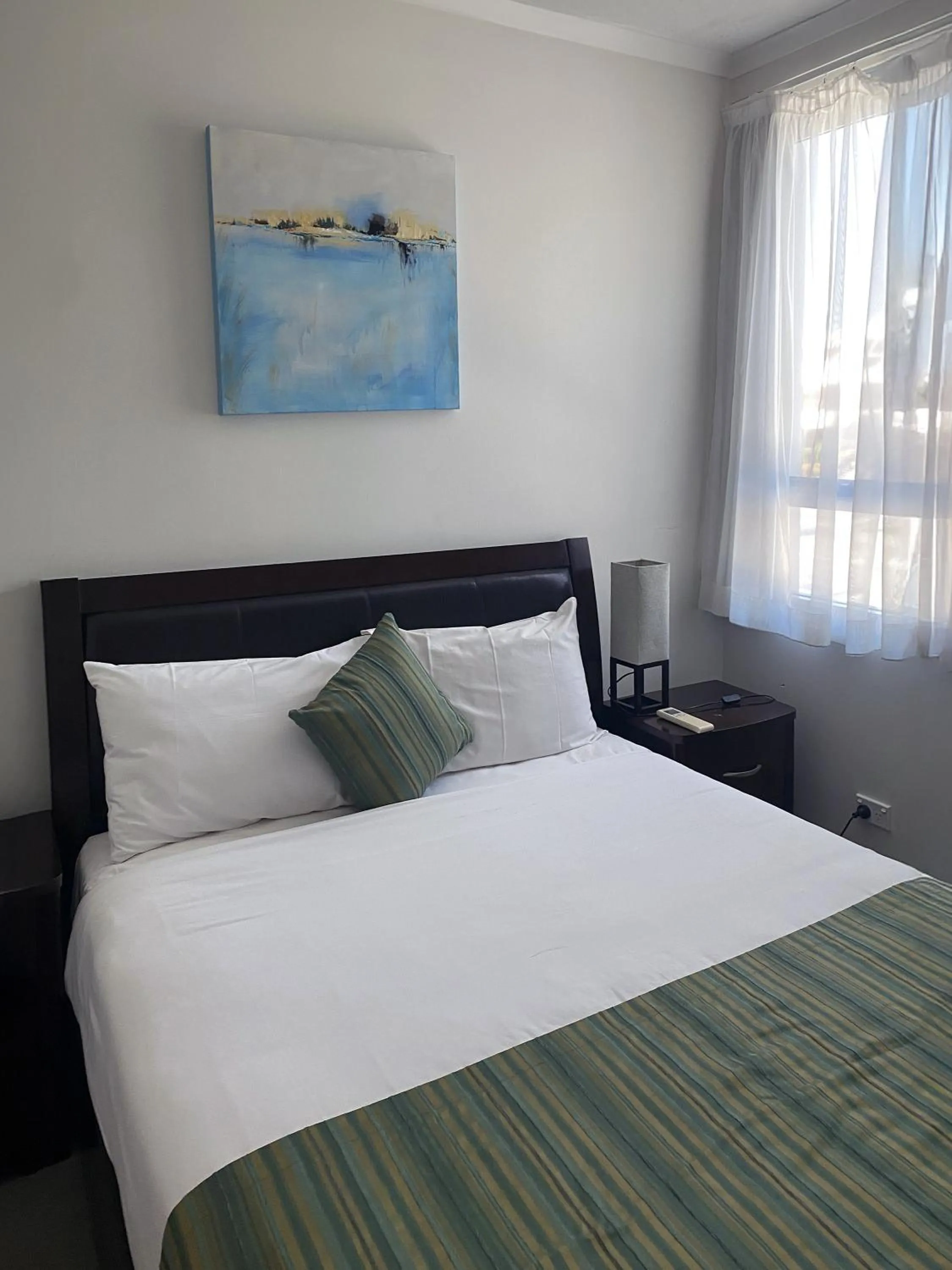 Bed in Curtis Central Apartments Official