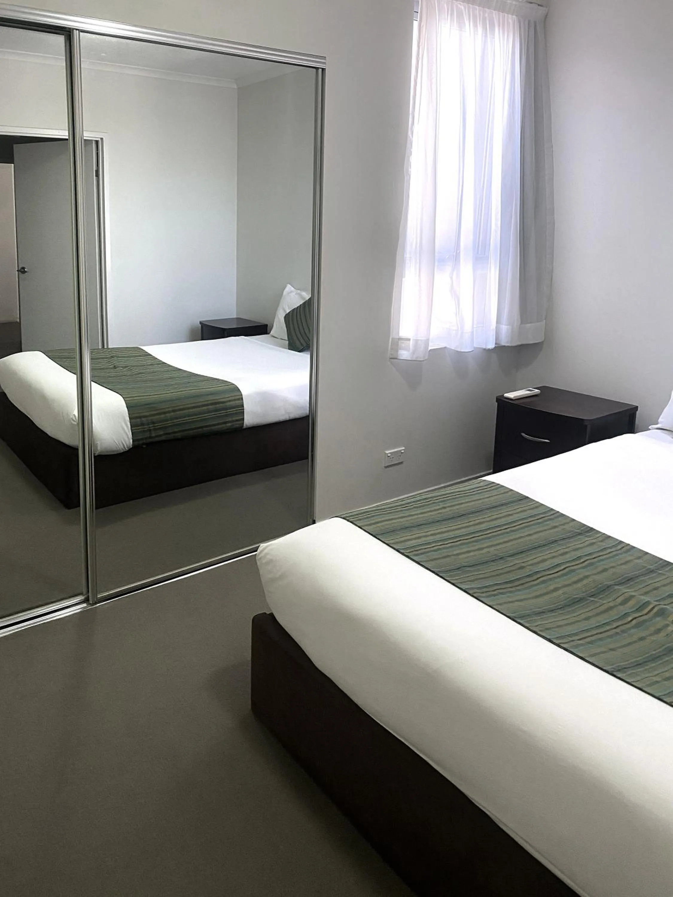 Bed in Curtis Central Apartments Official