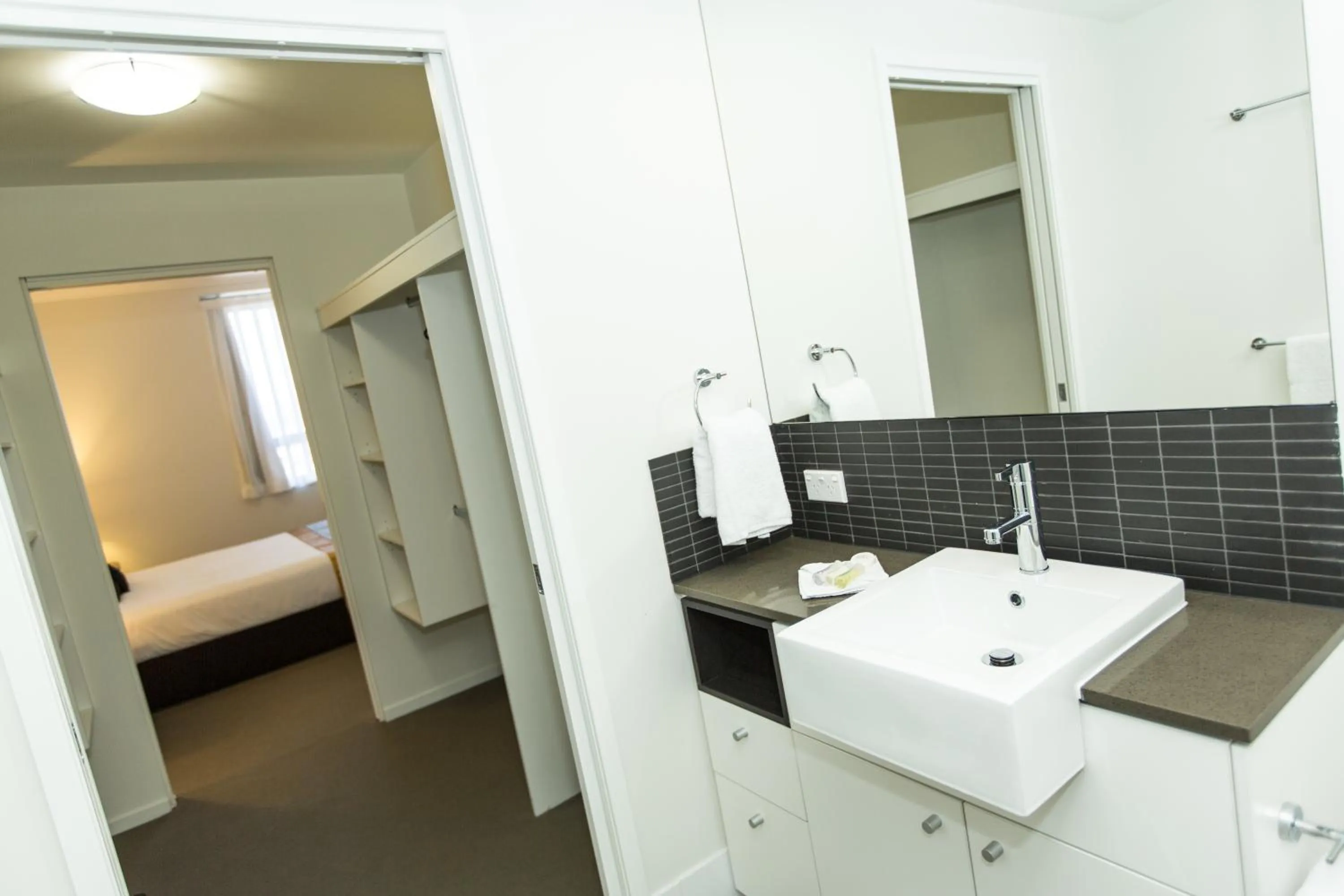 Bathroom, Bed in Curtis Central Apartments Official