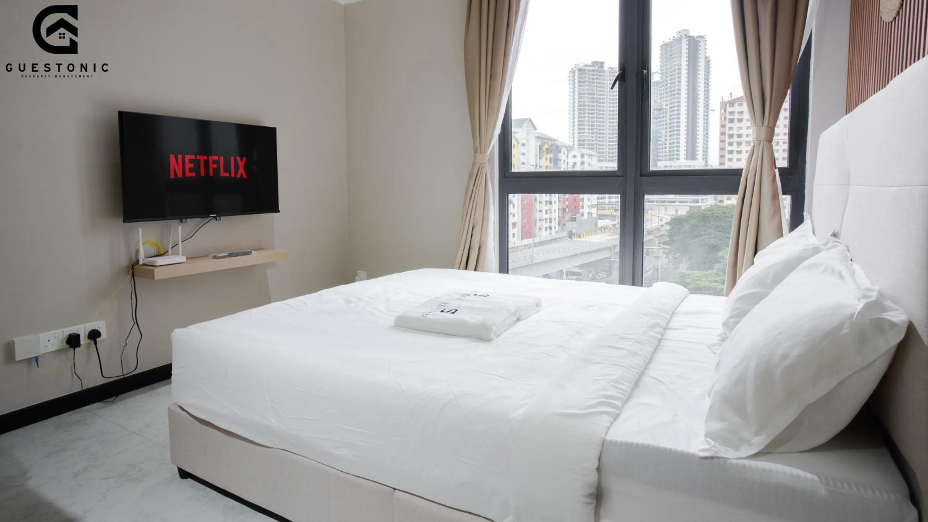 Bed in NeuSuite Cozy Studio by GUESTONIC