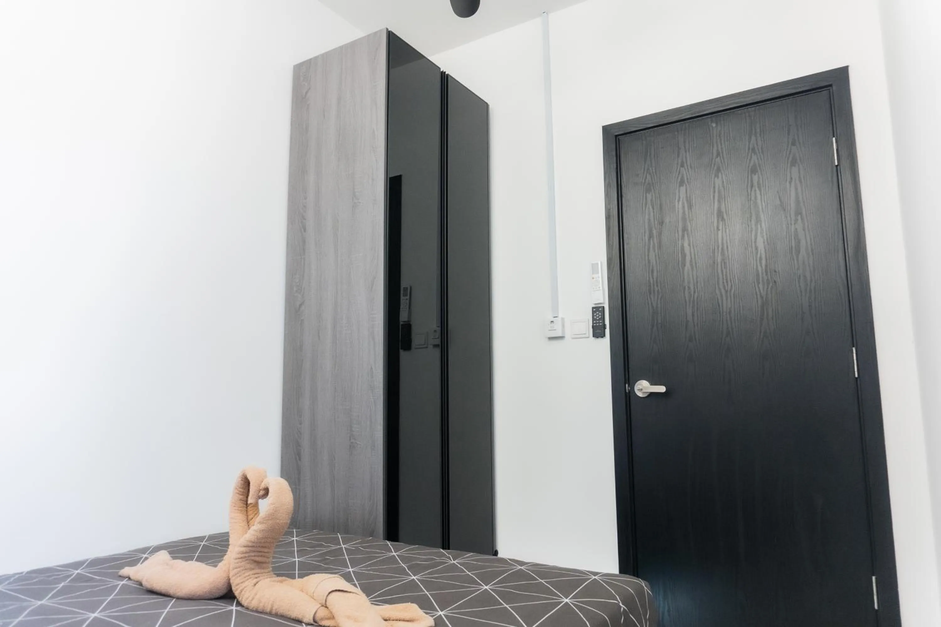 Bed in NeuSuite Cozy Studio by GUESTONIC