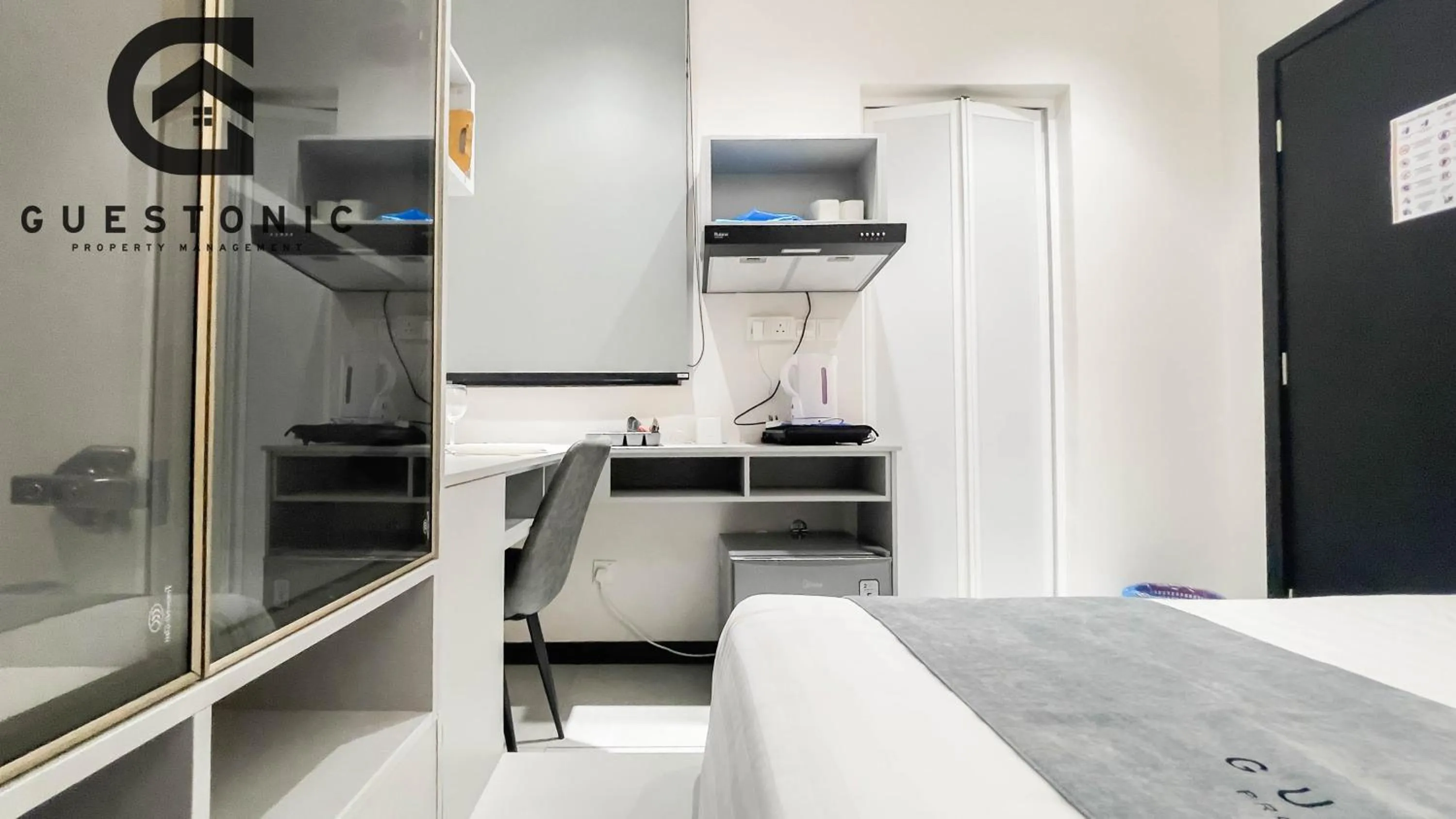 Bed in NeuSuite Cozy Studio by GUESTONIC