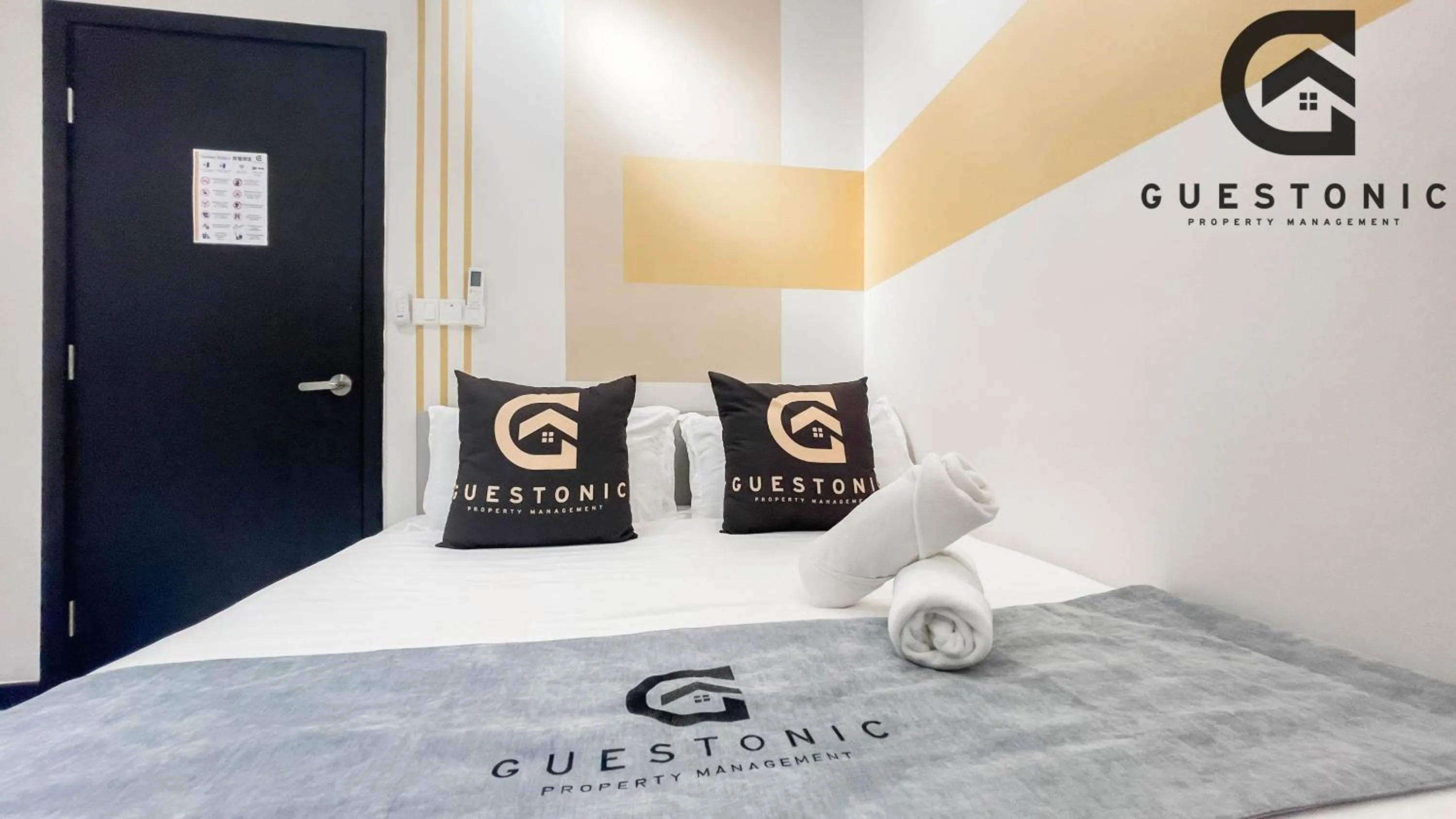 Bed in NeuSuite Cozy Studio by GUESTONIC