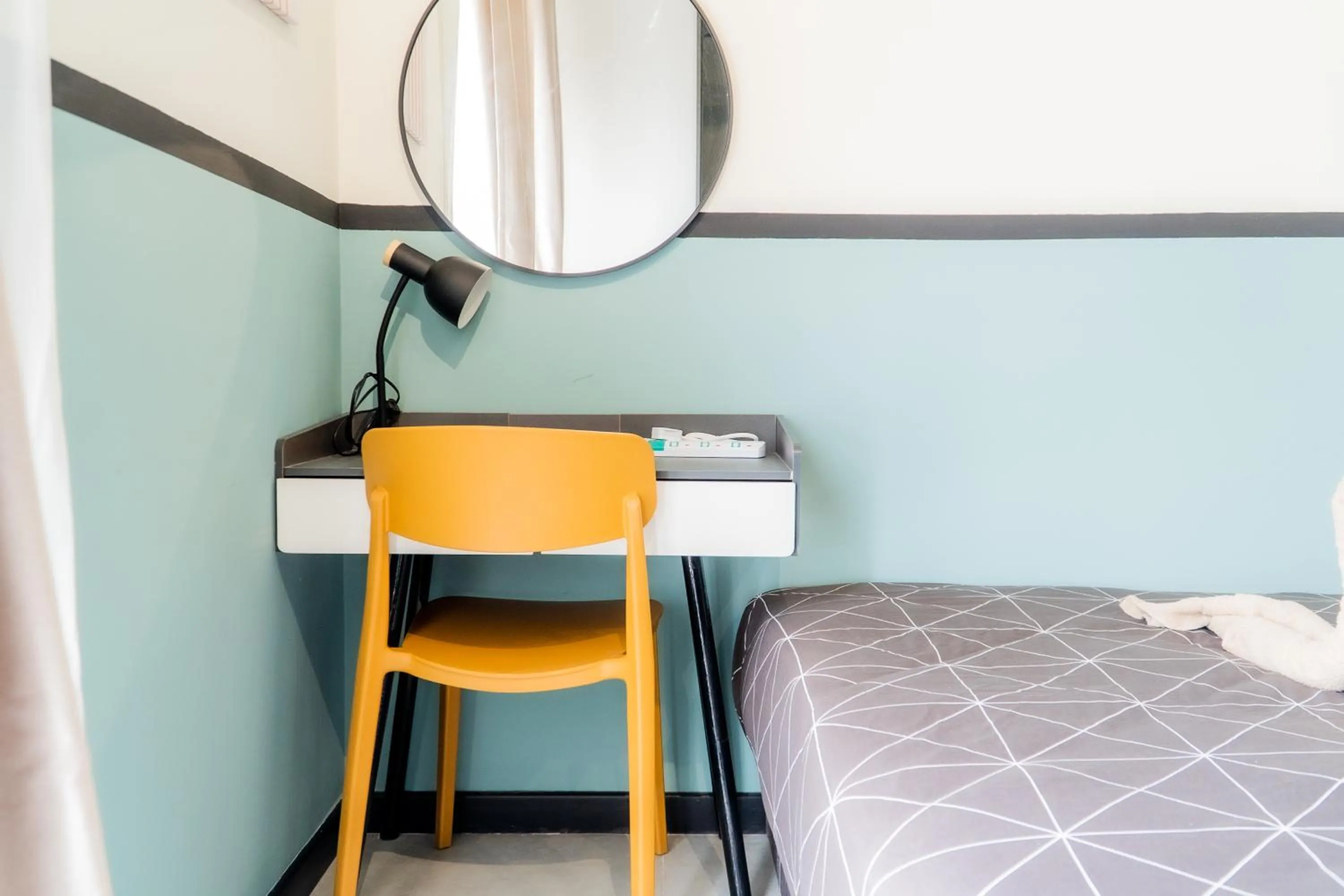 Bed in NeuSuite Cozy Studio by GUESTONIC