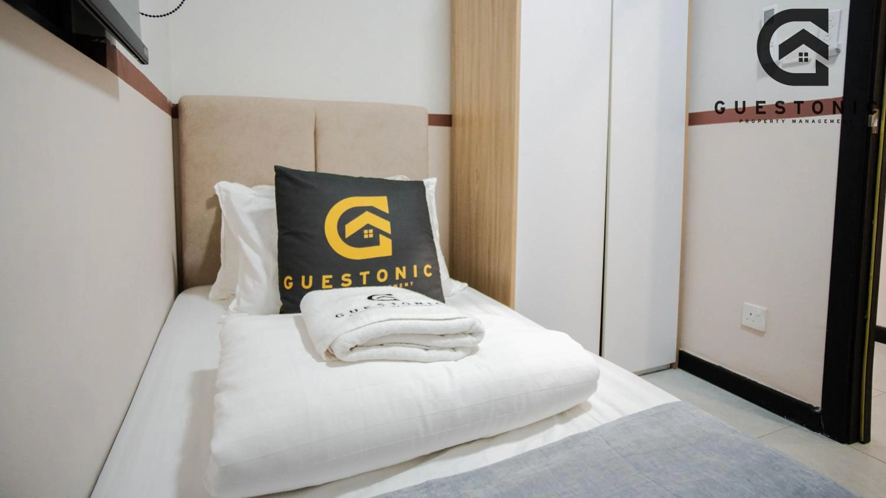 Bed in NeuSuite Cozy Studio by GUESTONIC