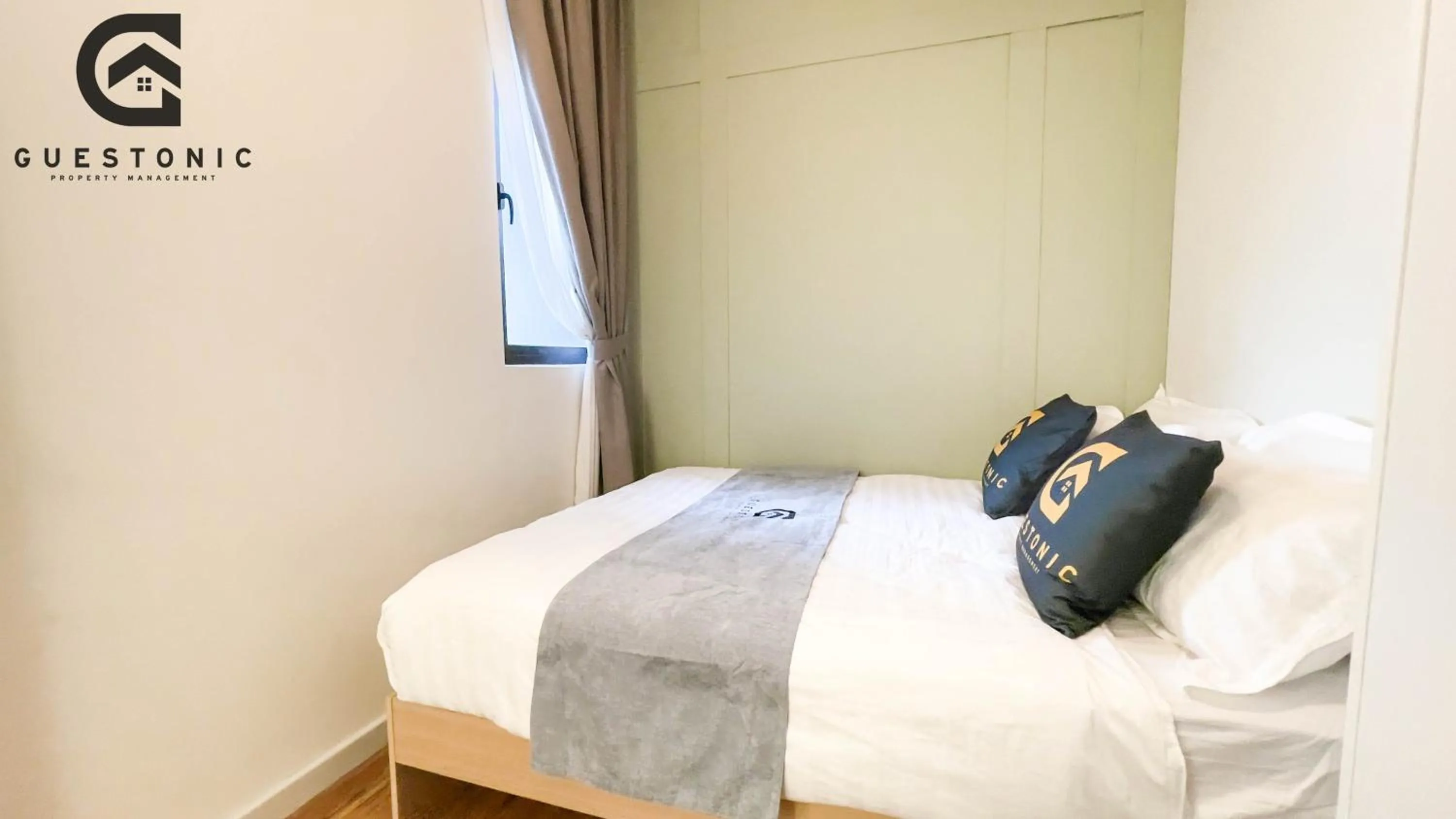 Bed in NeuSuite Cozy Studio by GUESTONIC