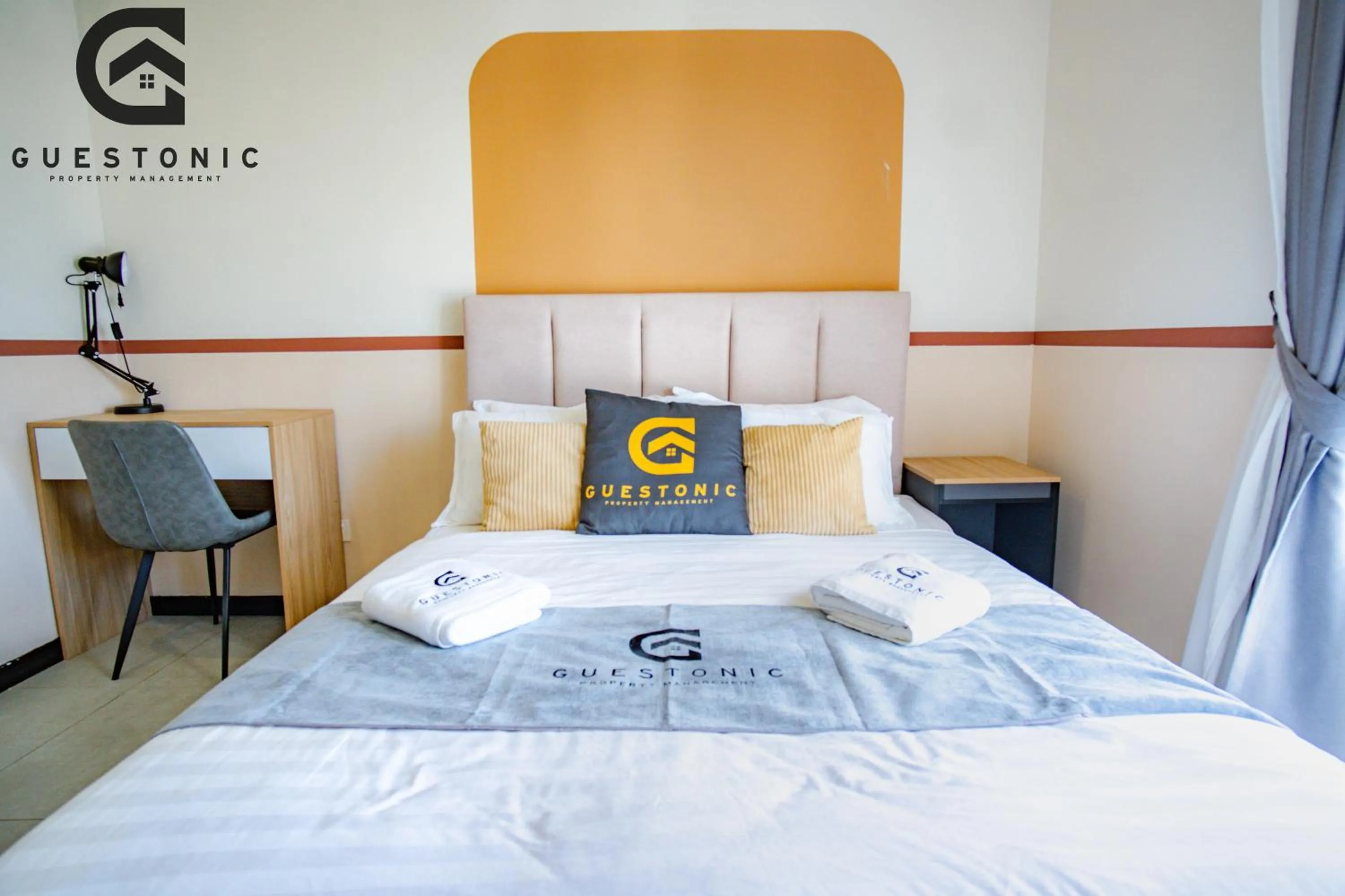 Bed in NeuSuite Cozy Studio by GUESTONIC