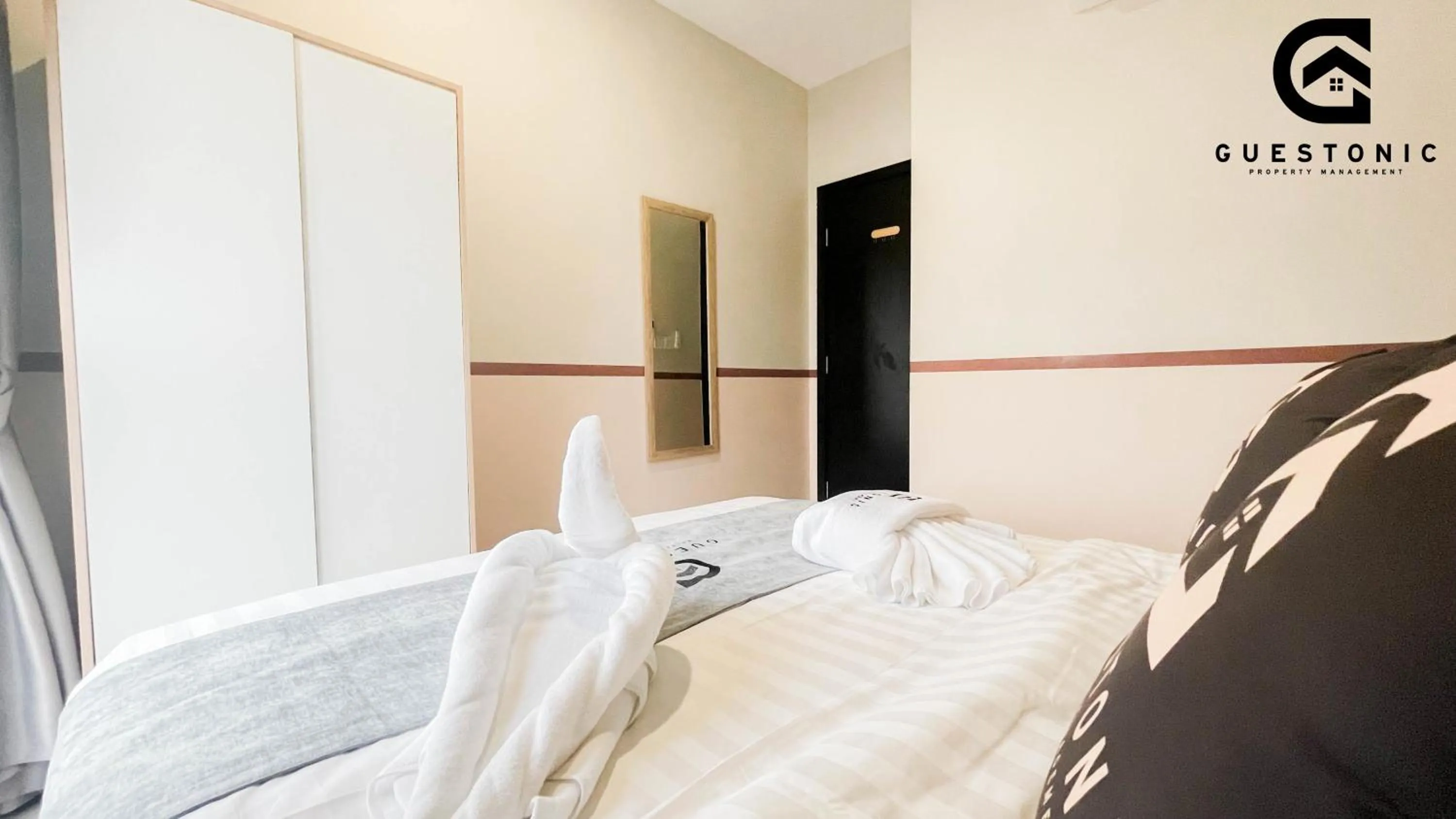 Bed in NeuSuite Cozy Studio by GUESTONIC