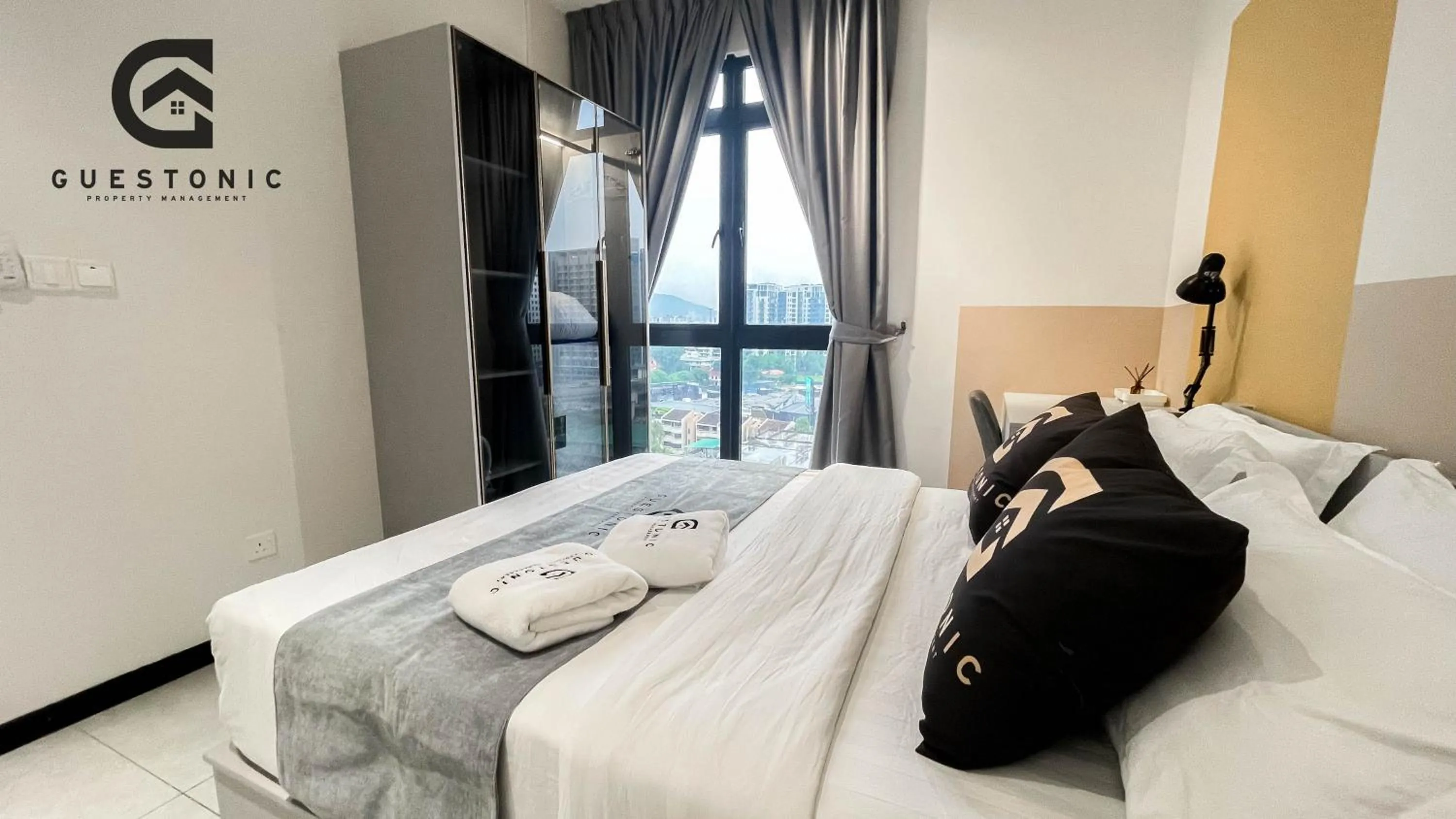 Bed in NeuSuite Cozy Studio by GUESTONIC