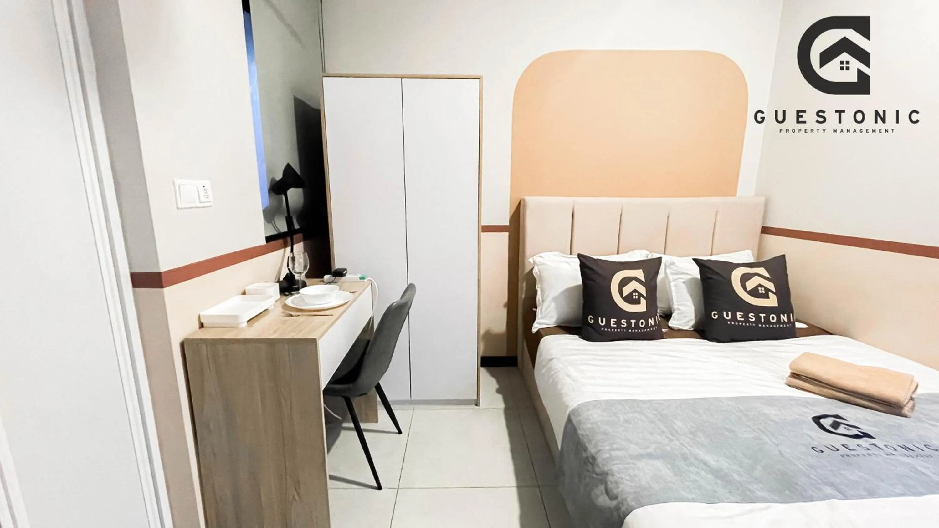 Bed in NeuSuite Cozy Studio by GUESTONIC