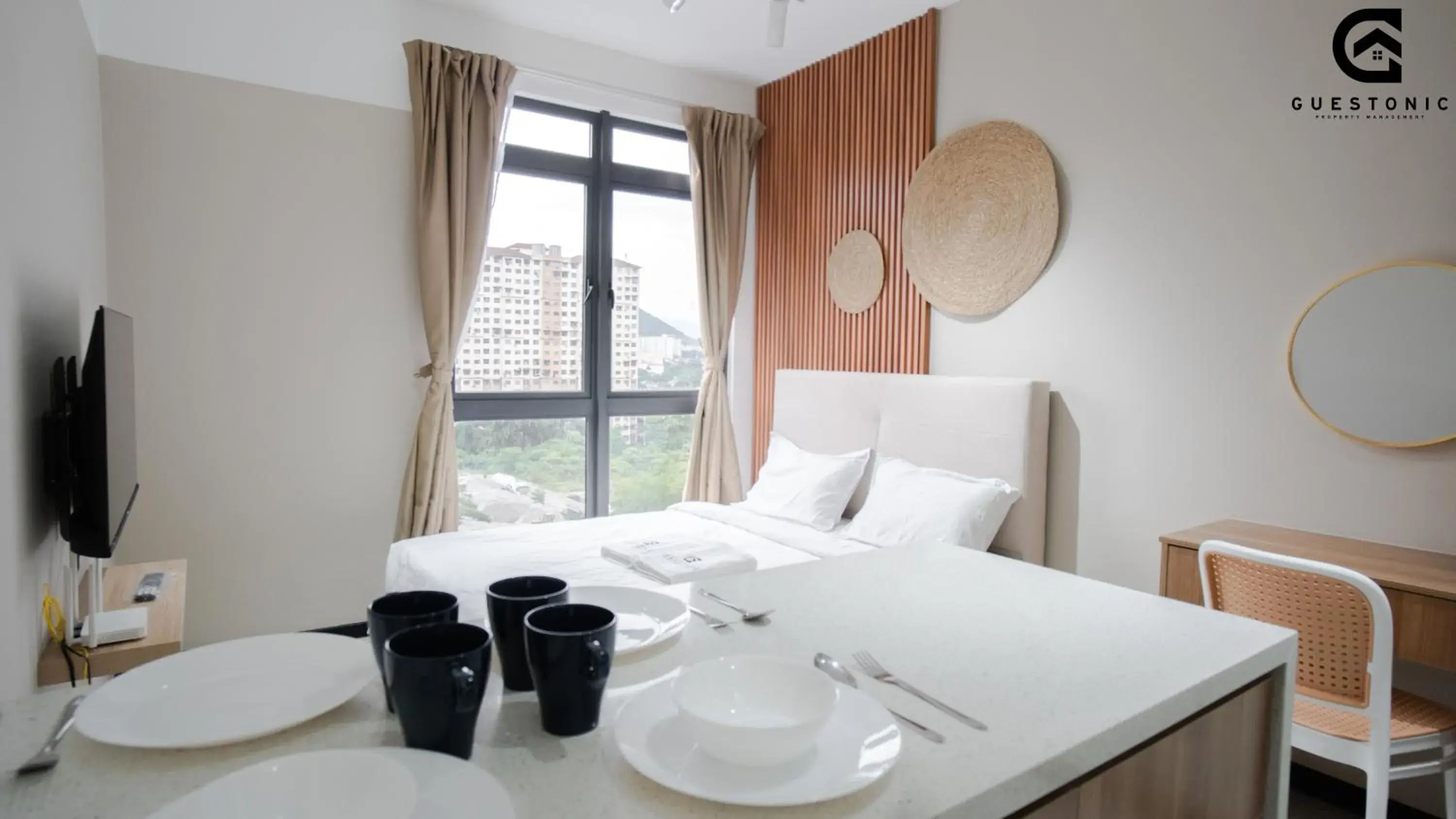 Bed in NeuSuite Cozy Studio by GUESTONIC Bed in NeuSuite Cozy Studio by GUESTONIC