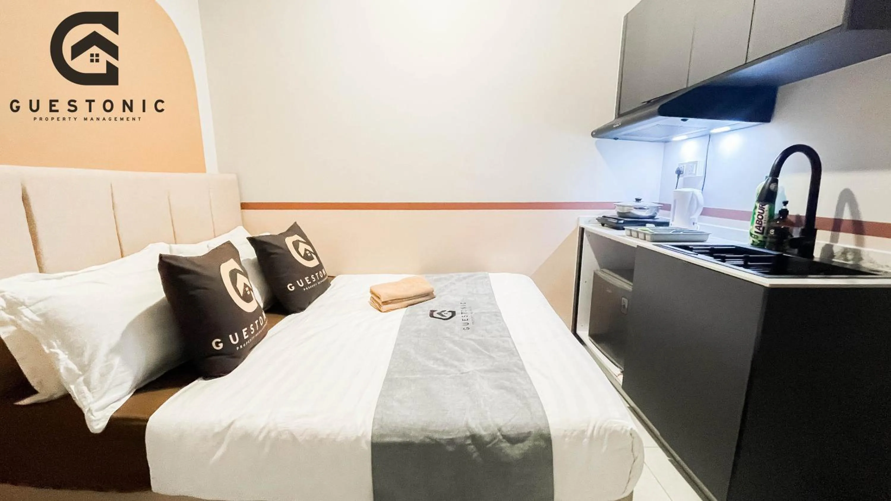 Bed in NeuSuite Cozy Studio by GUESTONIC