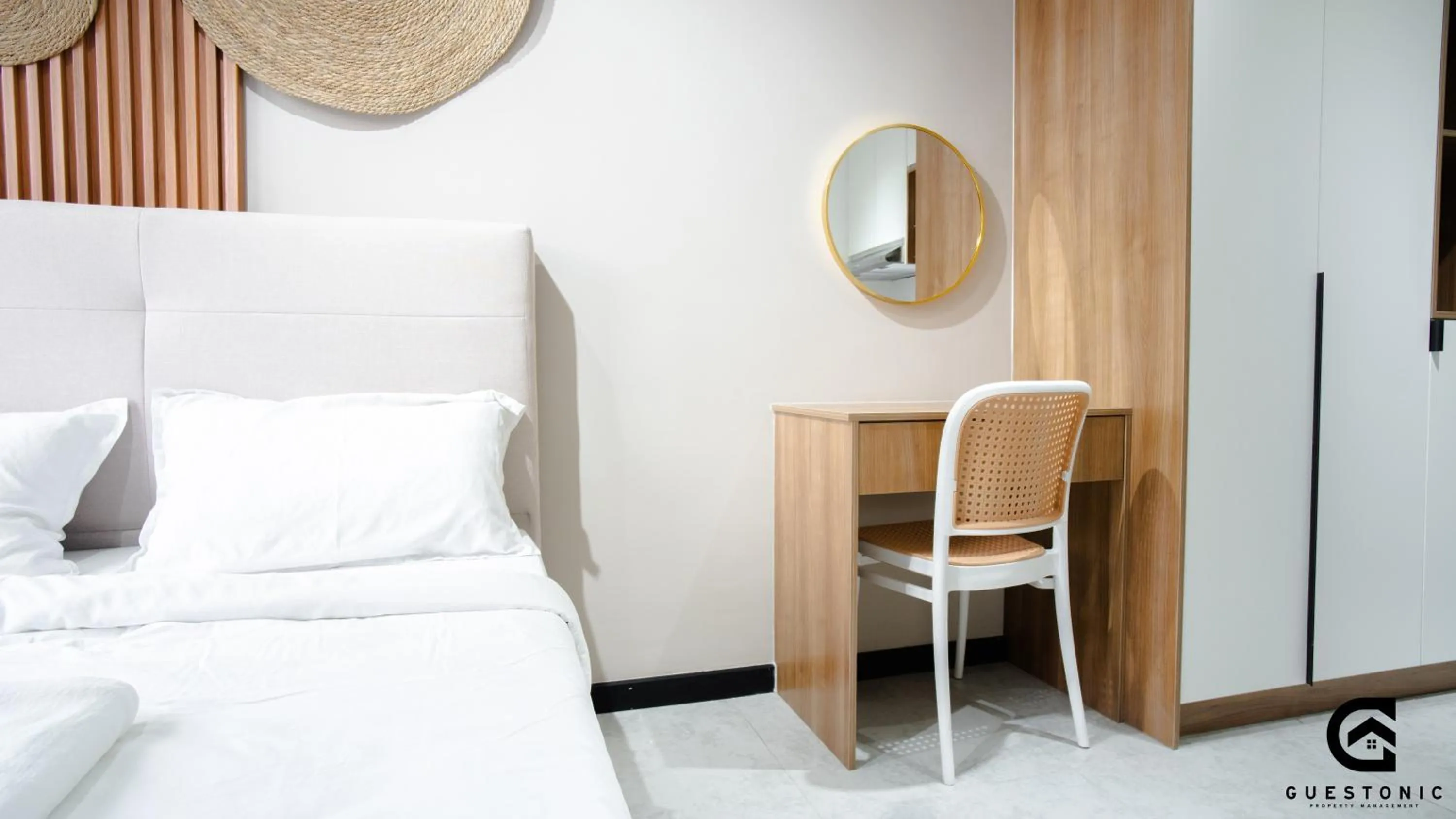 Bed in NeuSuite Cozy Studio by GUESTONIC