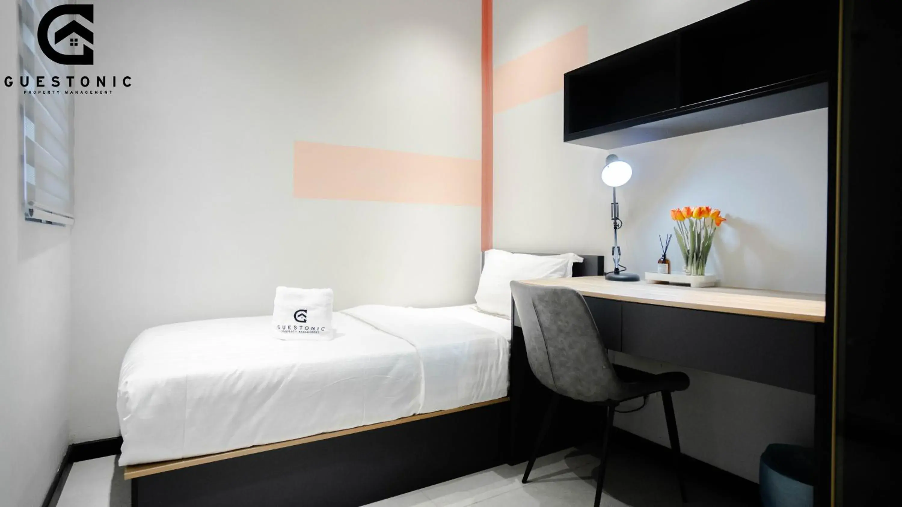 Bed in NeuSuite Cozy Studio by GUESTONIC Bed in NeuSuite Cozy Studio by GUESTONIC