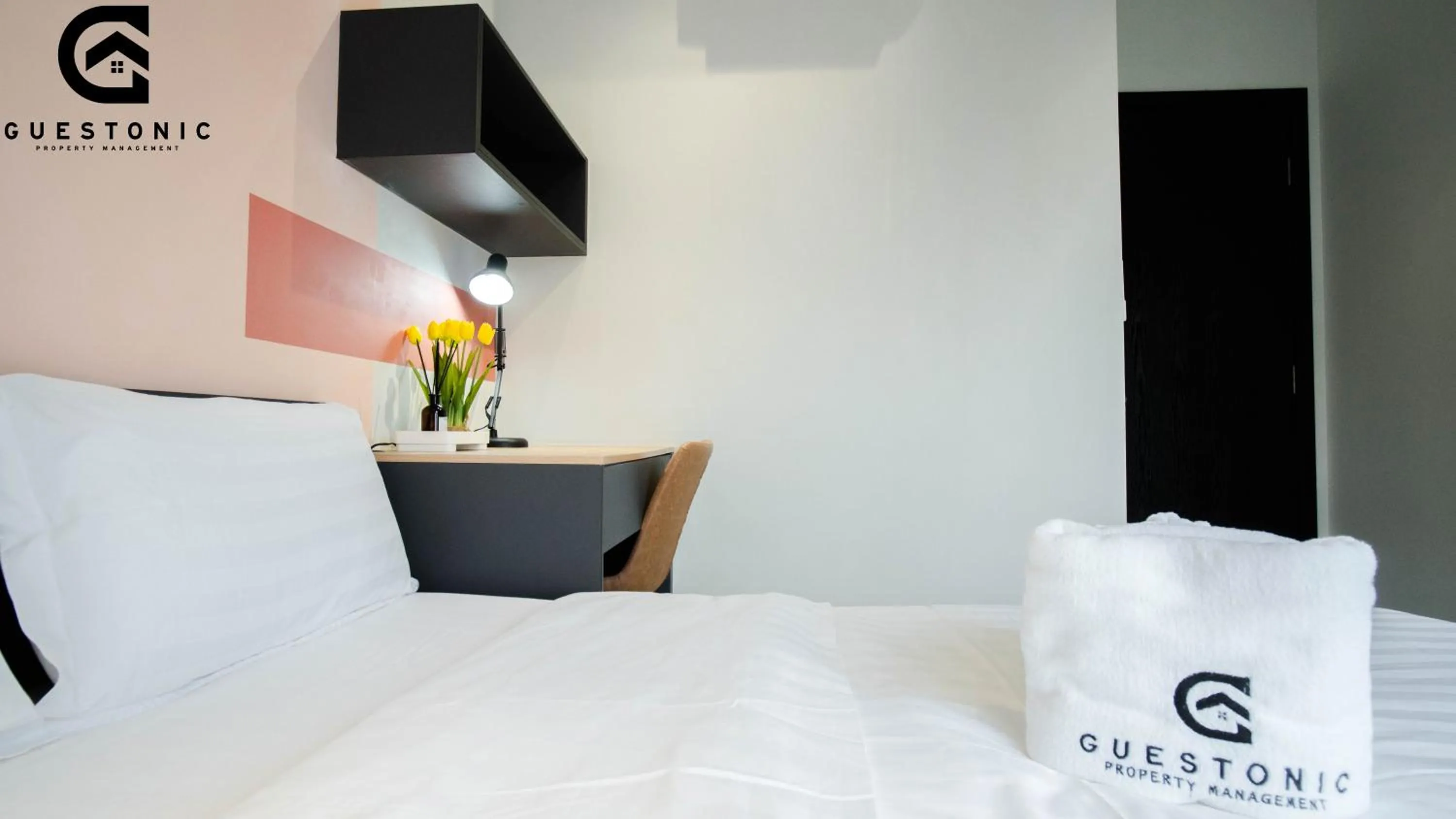 Bed in NeuSuite Cozy Studio by GUESTONIC