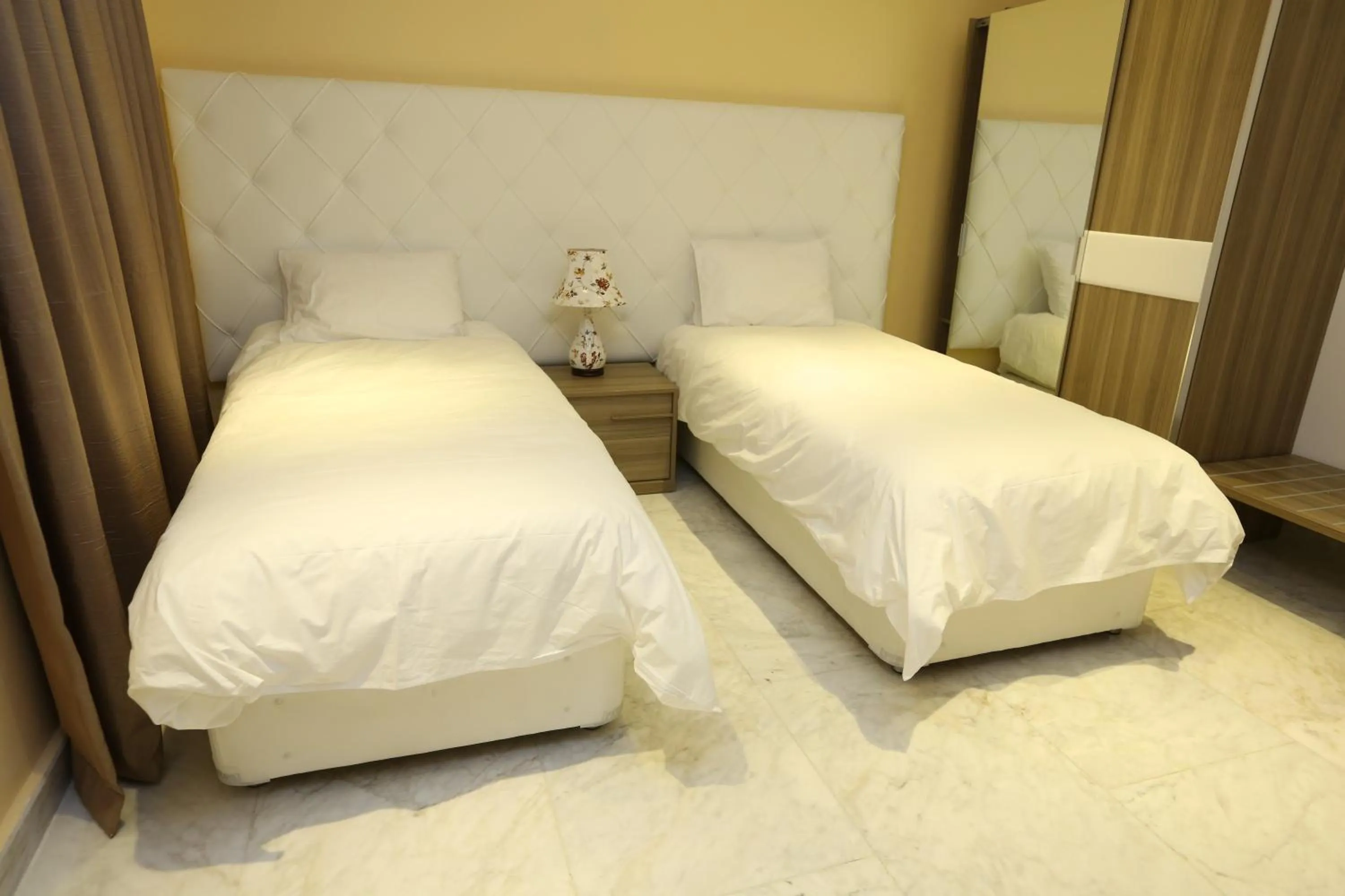Bed in Delora Hotel and Suites