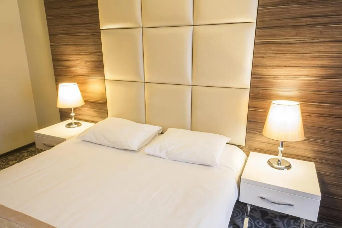 Bed in Derpa Suite Hotel