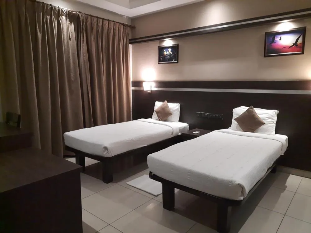 Bed in Hotel Nagarjuna Suites