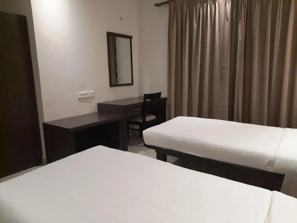 Bed in Hotel Nagarjuna Suites
