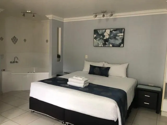 Bed in Charm City Motel