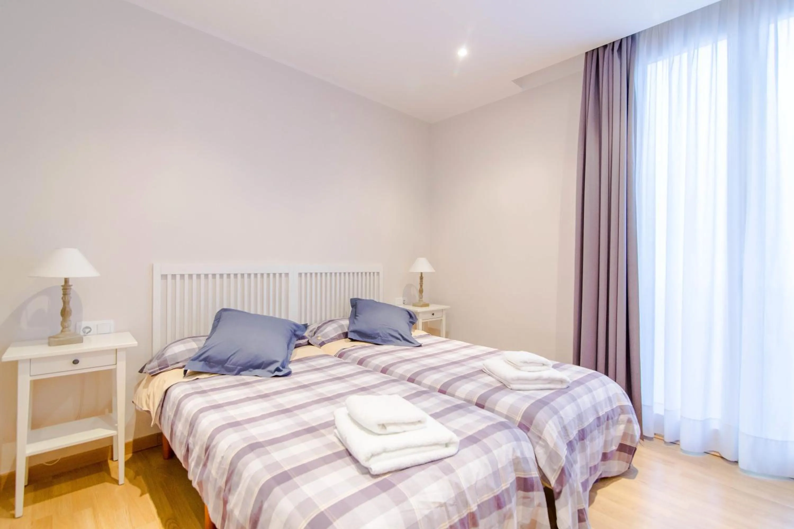 Bed in Pelayo Deluxe Apartments