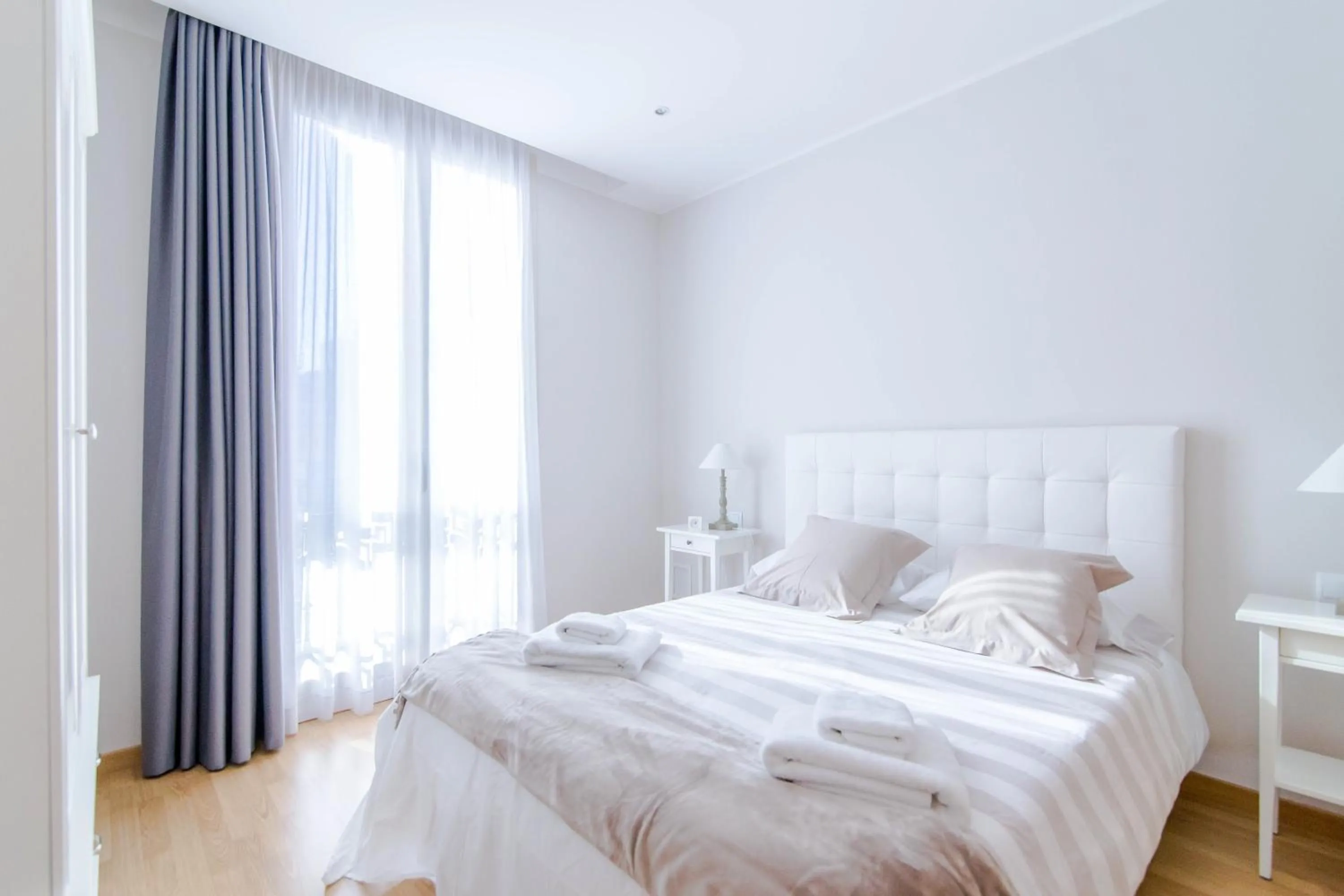 Bed in Pelayo Deluxe Apartments