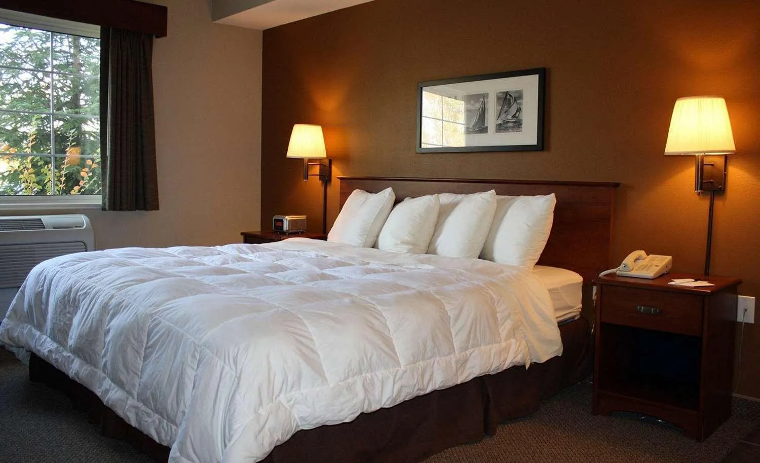 Bed in AmericInn by Wyndham Charlevoix