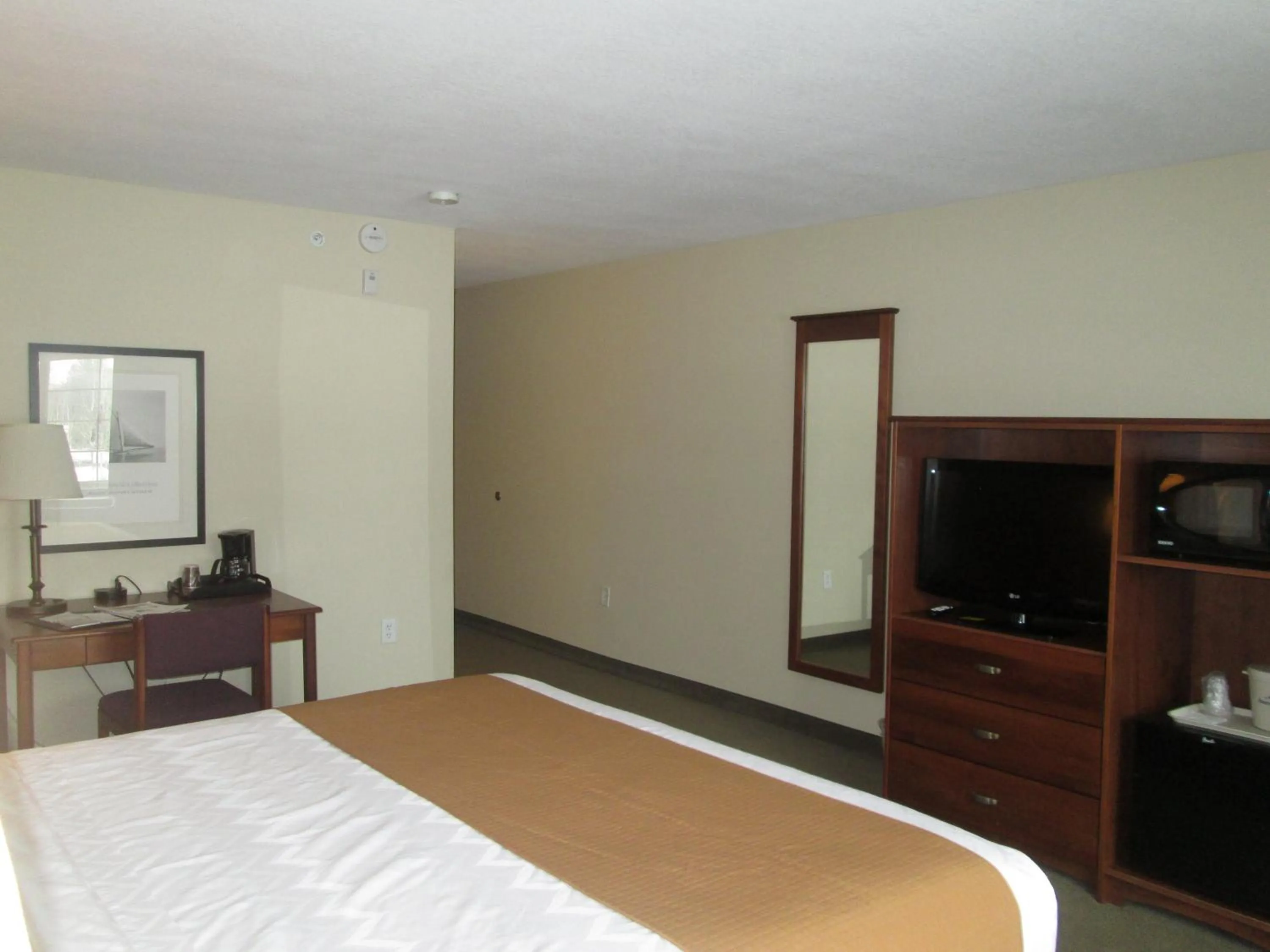 Bed in AmericInn by Wyndham Charlevoix