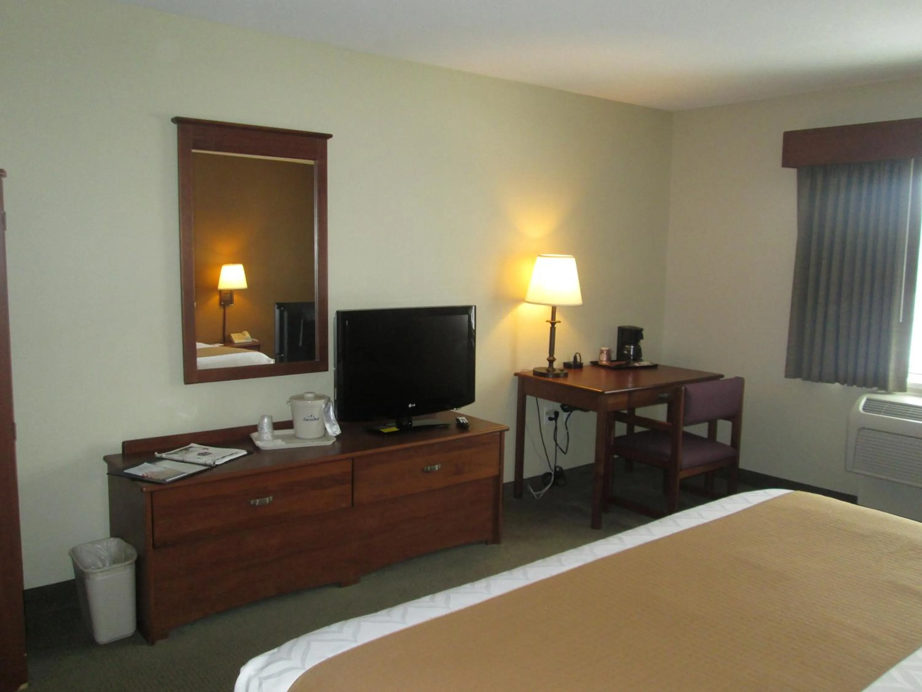 Bed in AmericInn by Wyndham Charlevoix
