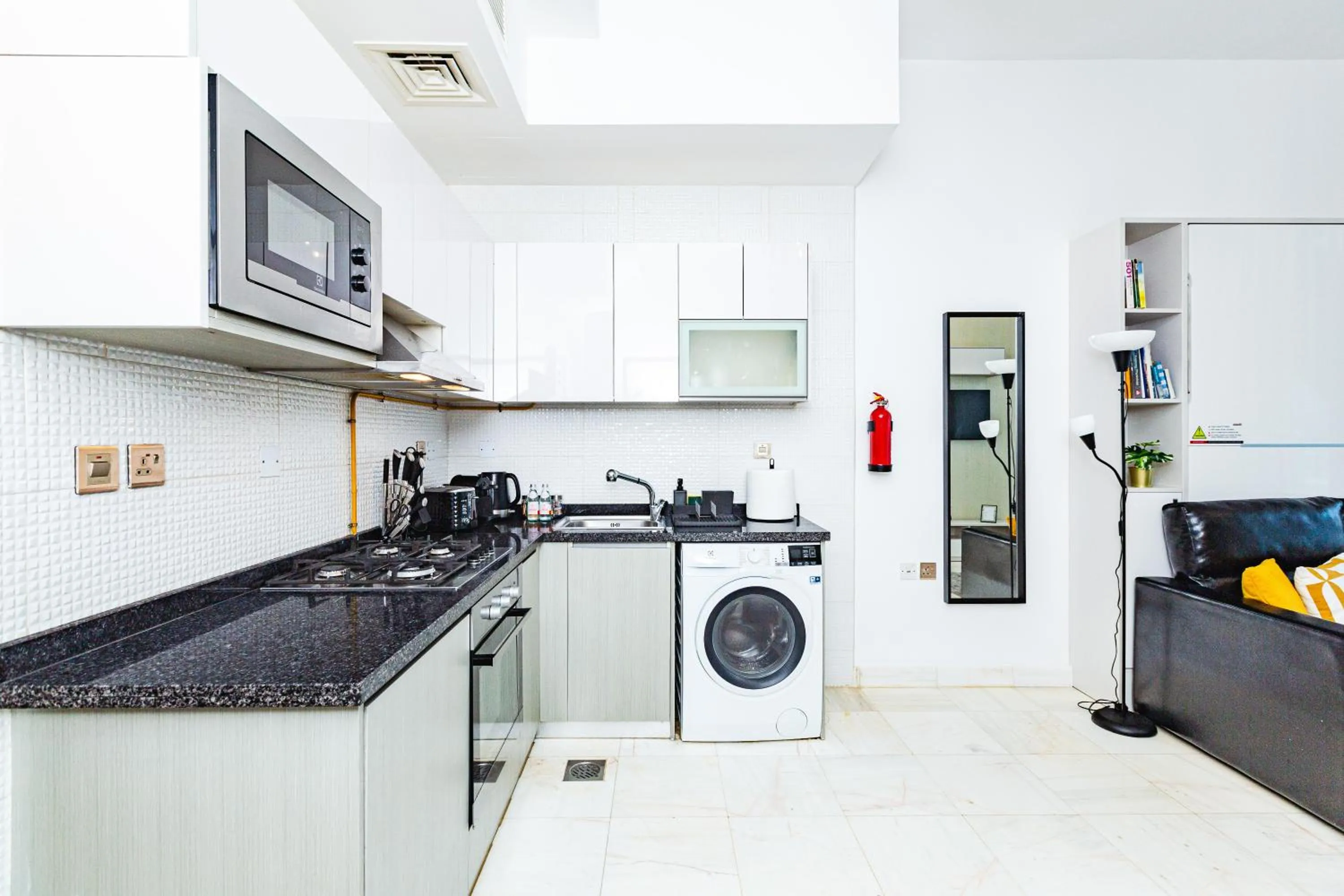 Kitchen or kitchenette in Waves Holiday Homes - Chic Studio With Balcony Overlooking City Views