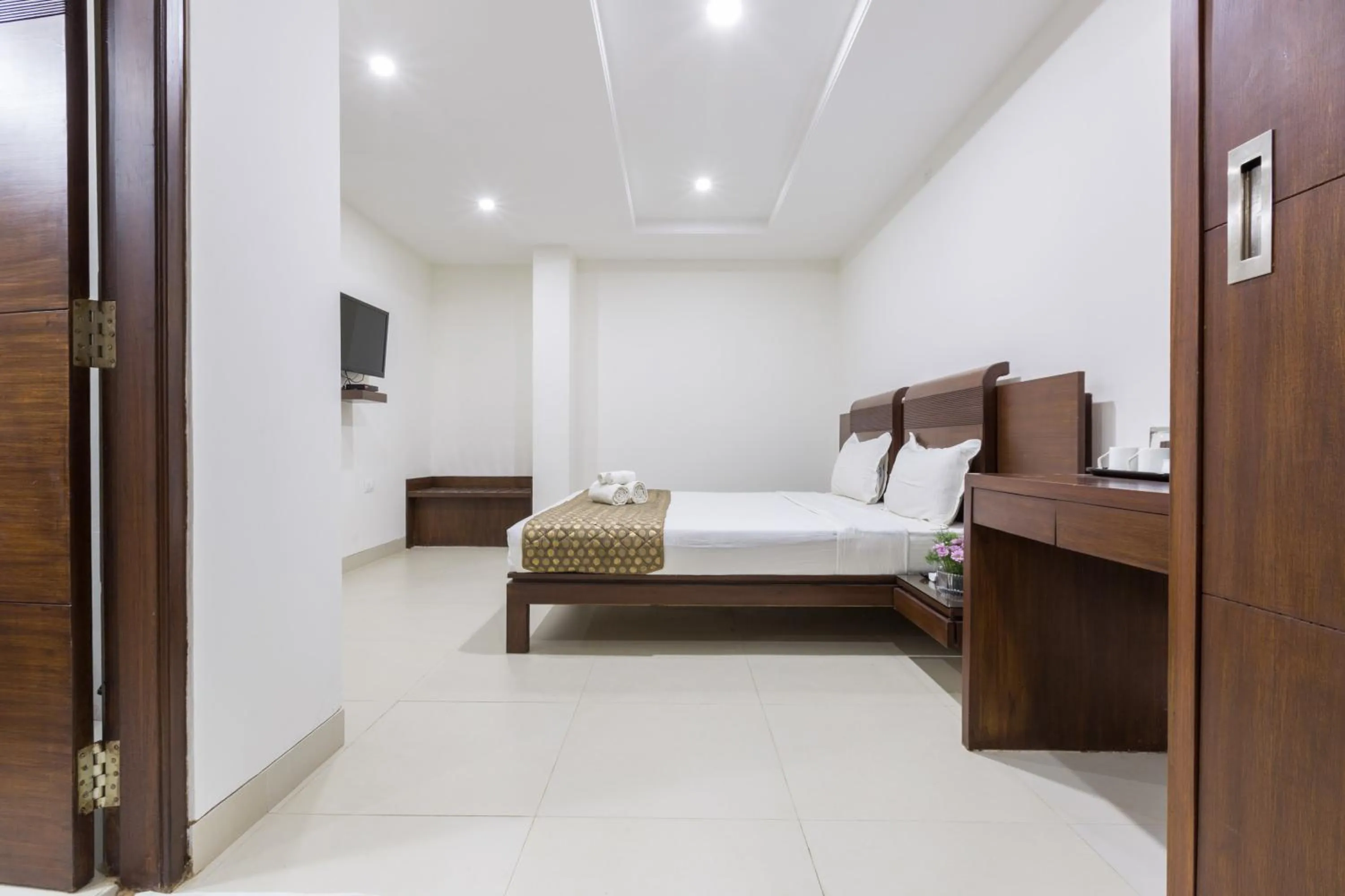 Photo of the whole room, Bed in Sanctum Suites BEL Road Bangalore