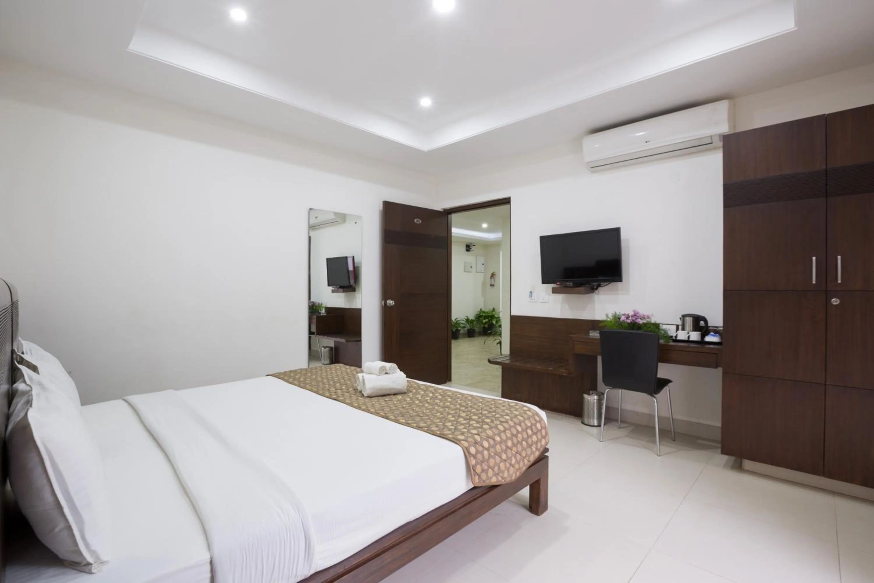 Photo of the whole room, Bed in Sanctum Suites BEL Road Bangalore