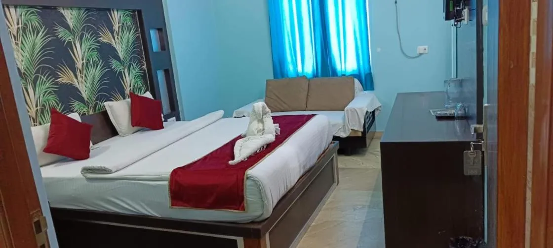 Communal lounge/ TV room, Bed in Hotel Nirmala Inn