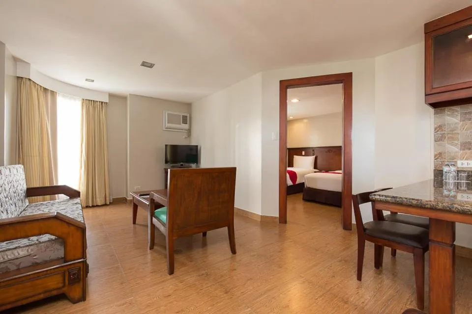 Living room, Bed in MJ Hotel and Suites