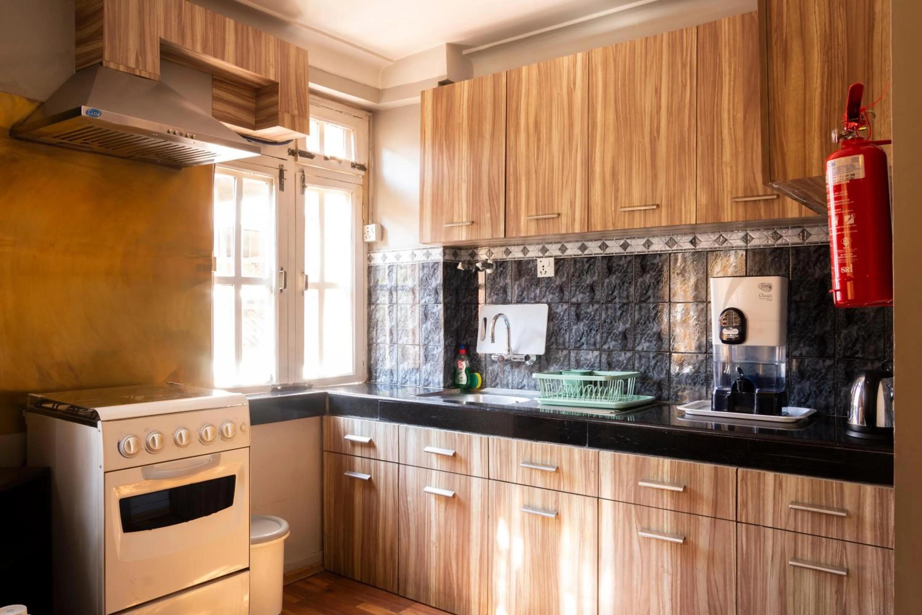 Kitchen or kitchenette in Shaligram Hotel