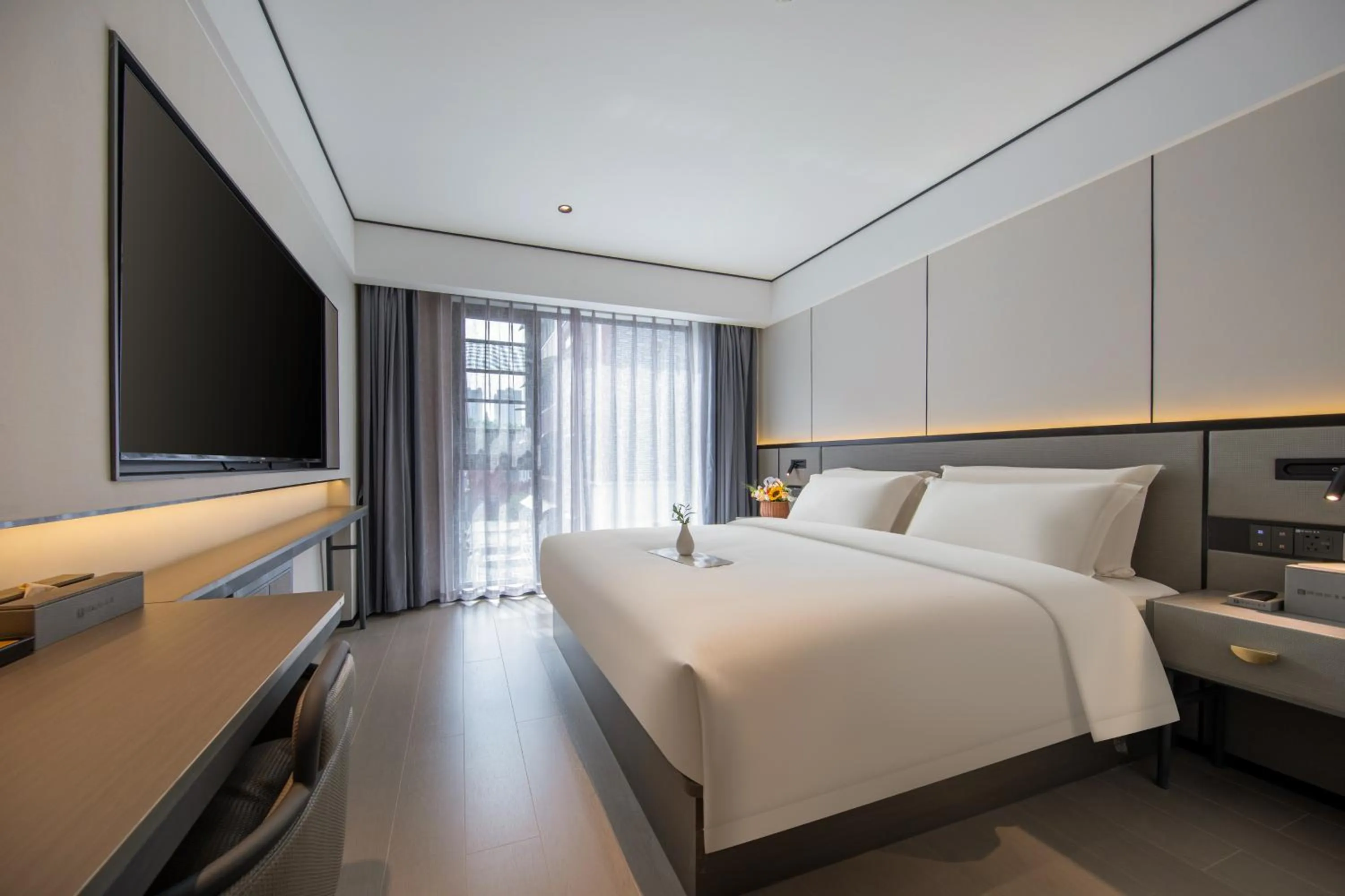 Communal lounge/ TV room, Bed in Gongxili - Xige Hotel Free Welcome Tea and Dessert