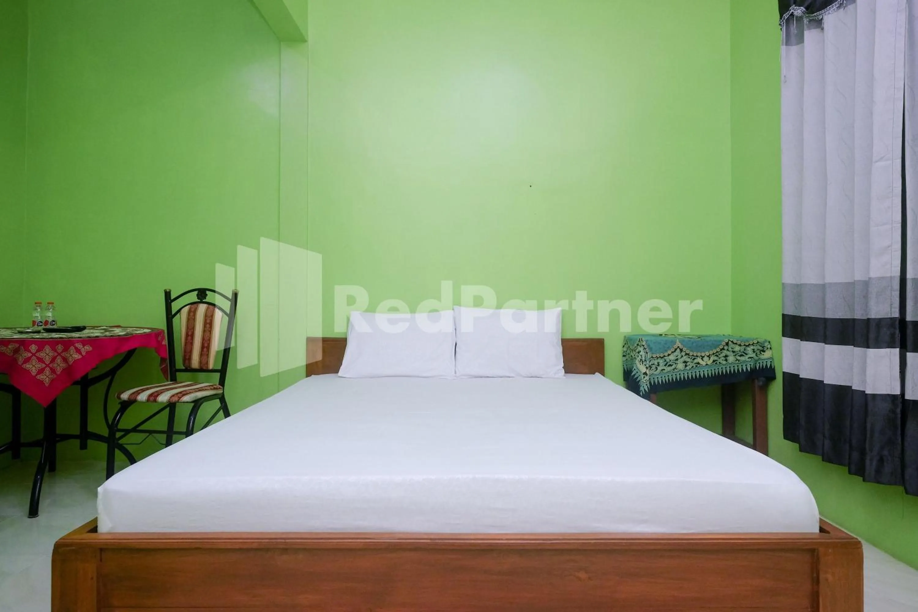 Bed in Wisma Giri Mulyo B near Grojogan Sewu Mitra RedDoorz