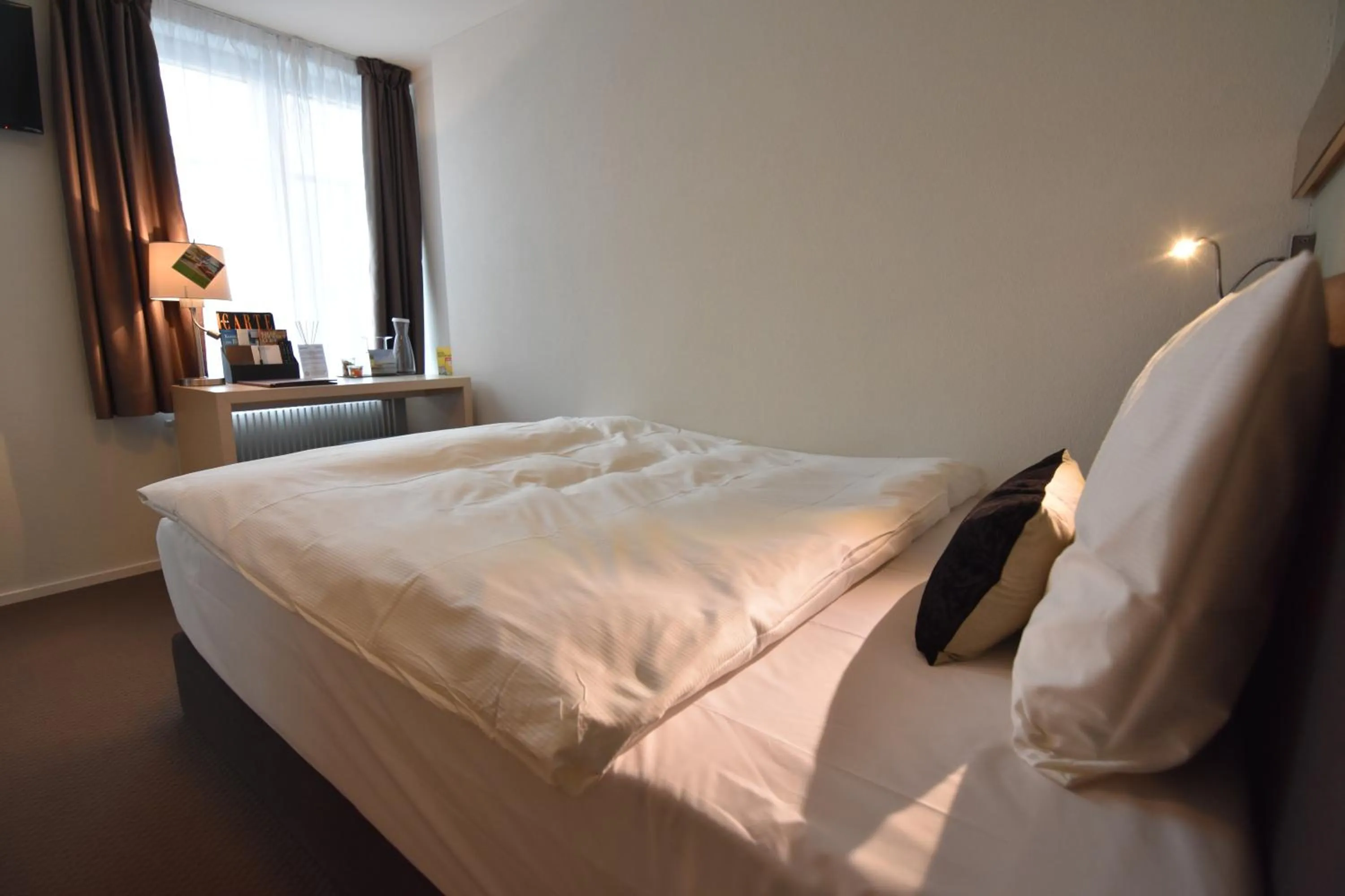 Bed in JUCKERs Boutique-Hotel