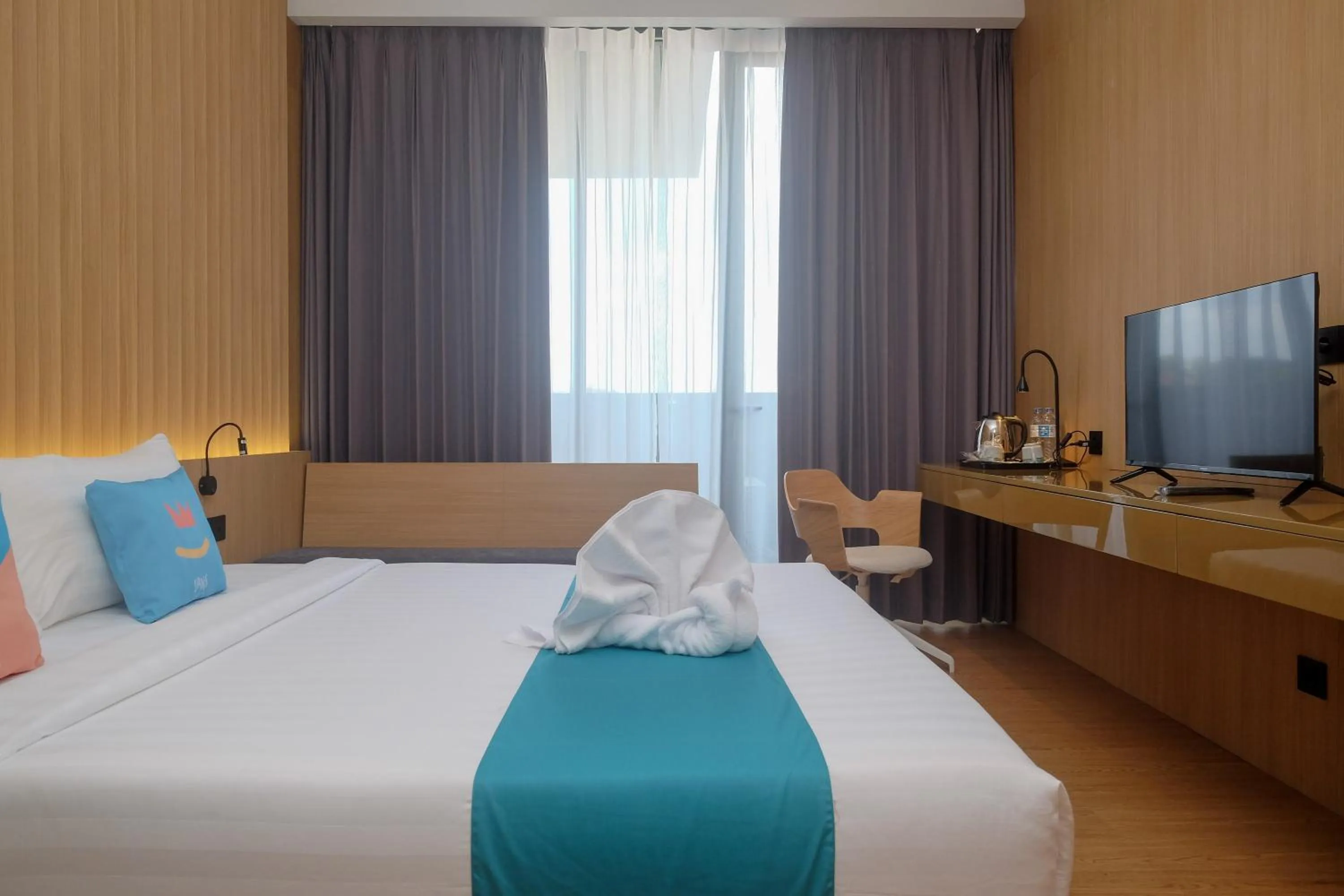 Bed in Sans Hotel RG Living Jogja by RedDoorz