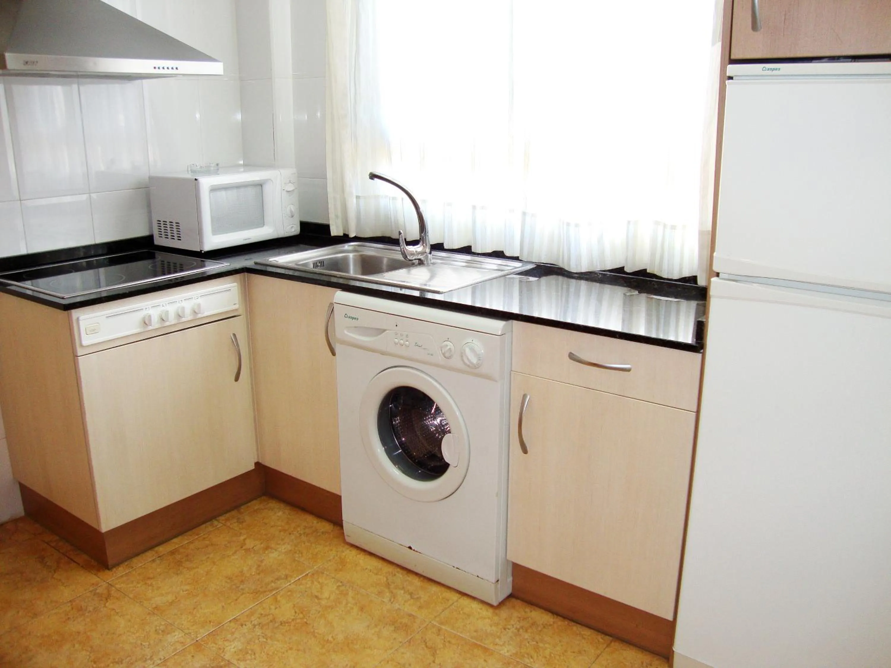 Kitchen or kitchenette in Apartamentos Marcomar 3000