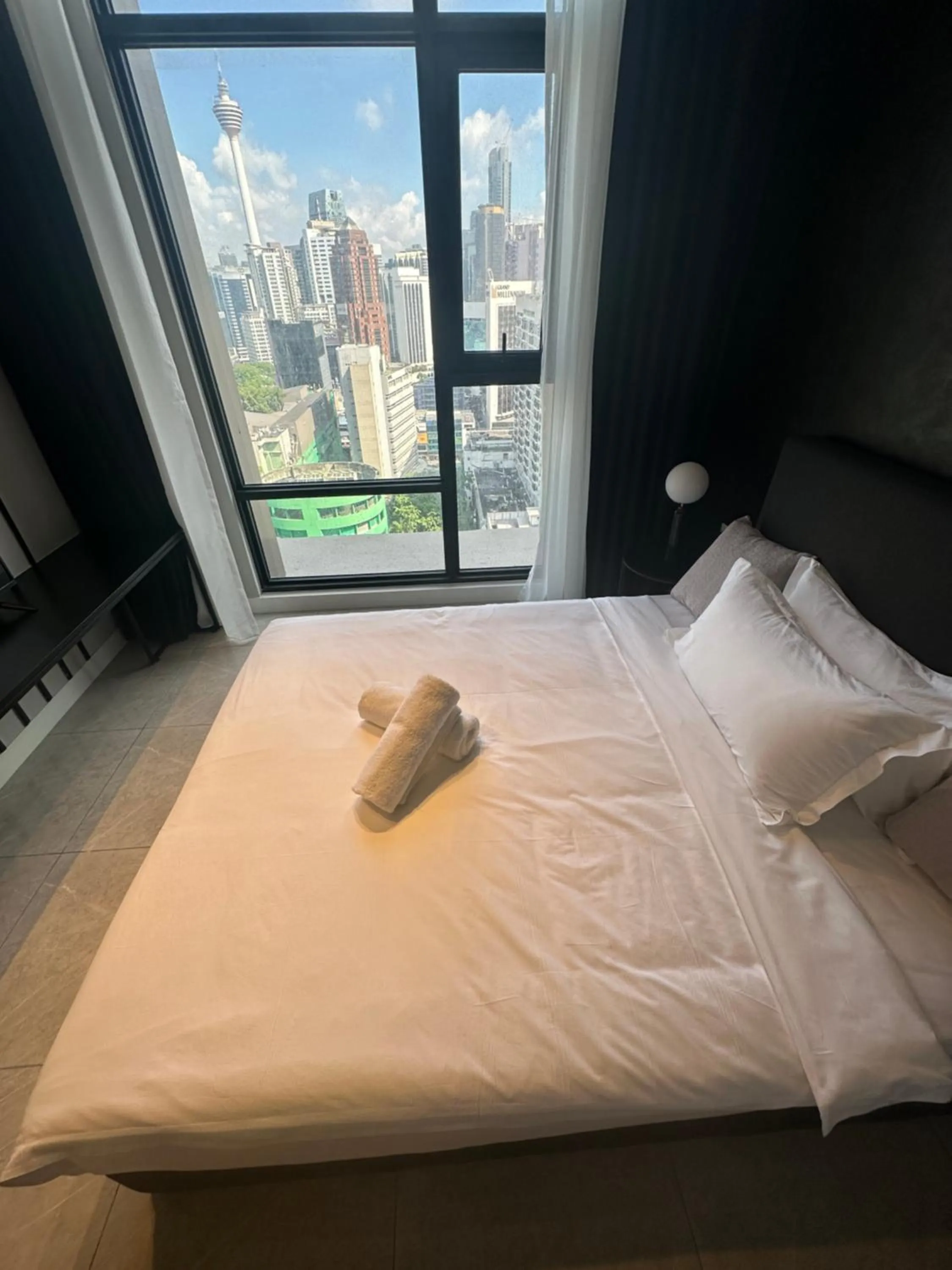 Bed in Axon Residence at Pavilion KLCC KL Tower view by KIMIRO