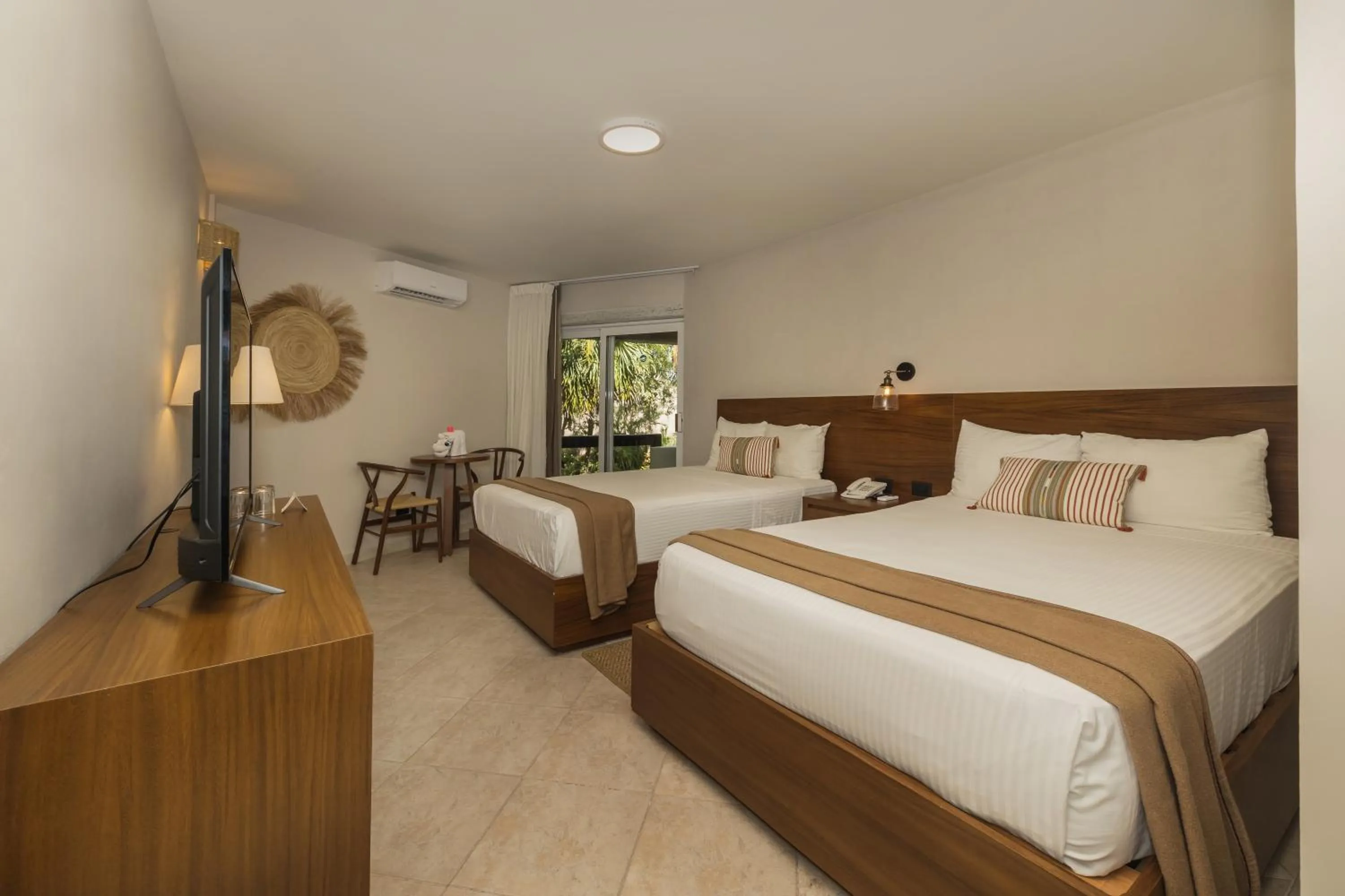 Bed in Casa del Mar Cozumel Hotel & Dive Resort with free access to an exclusive beach club
